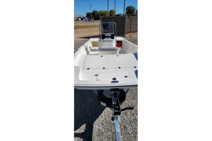 2026 Mako Pro Skiff 17 CC boat on trailer, parked outdoors.