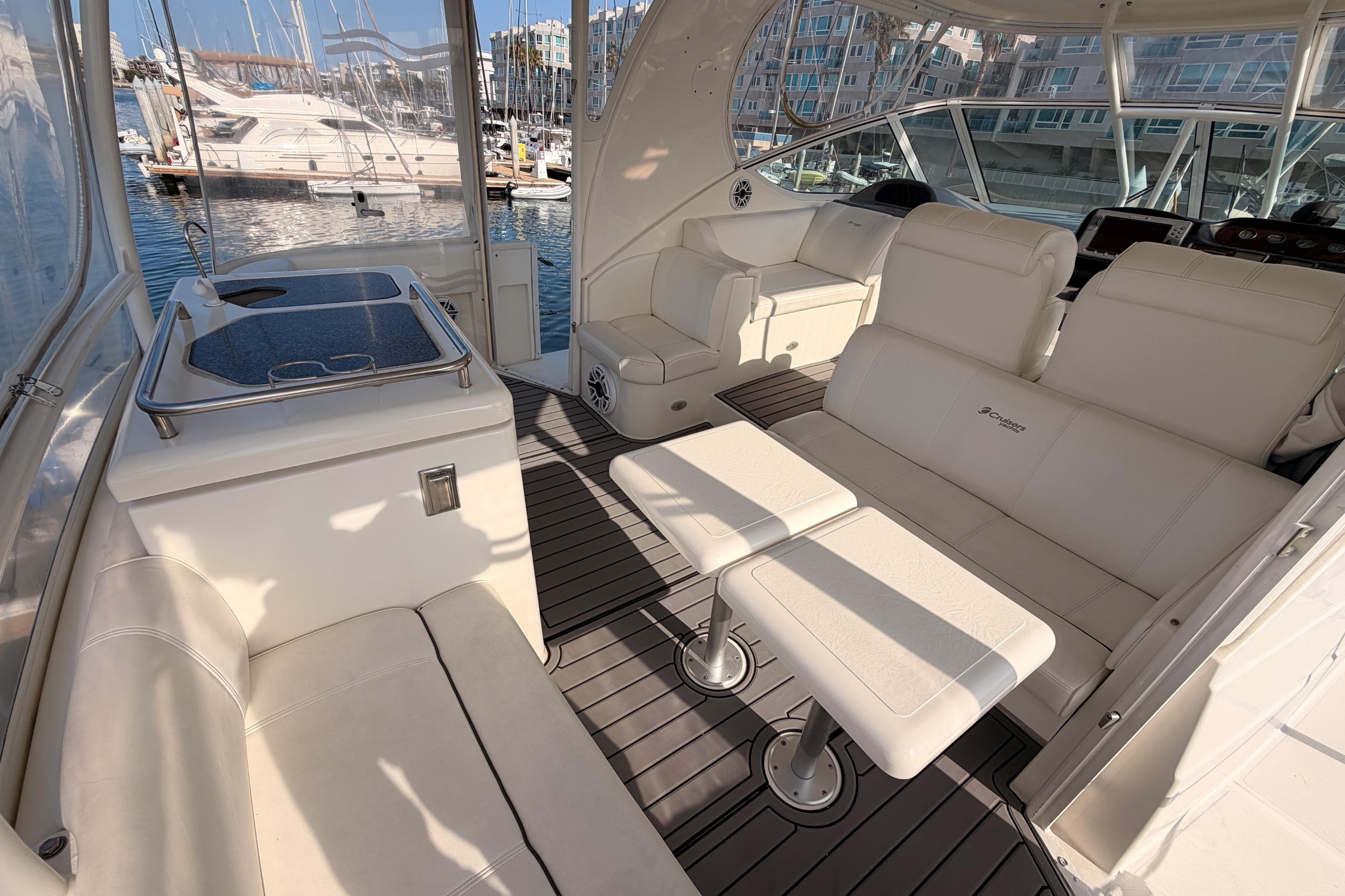 2005 Cruisers Yachts 405 Express Motoryacht interior with white seating and marina view.
