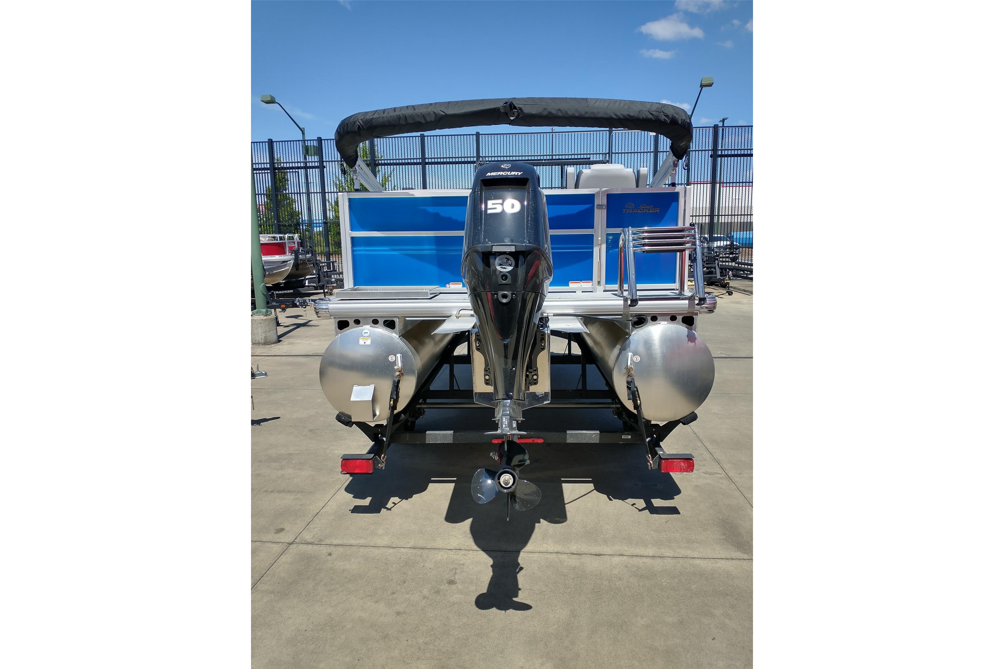 2026 Sun Tracker Party Barge 16 DLX pontoon boat with outboard motor, rear view.