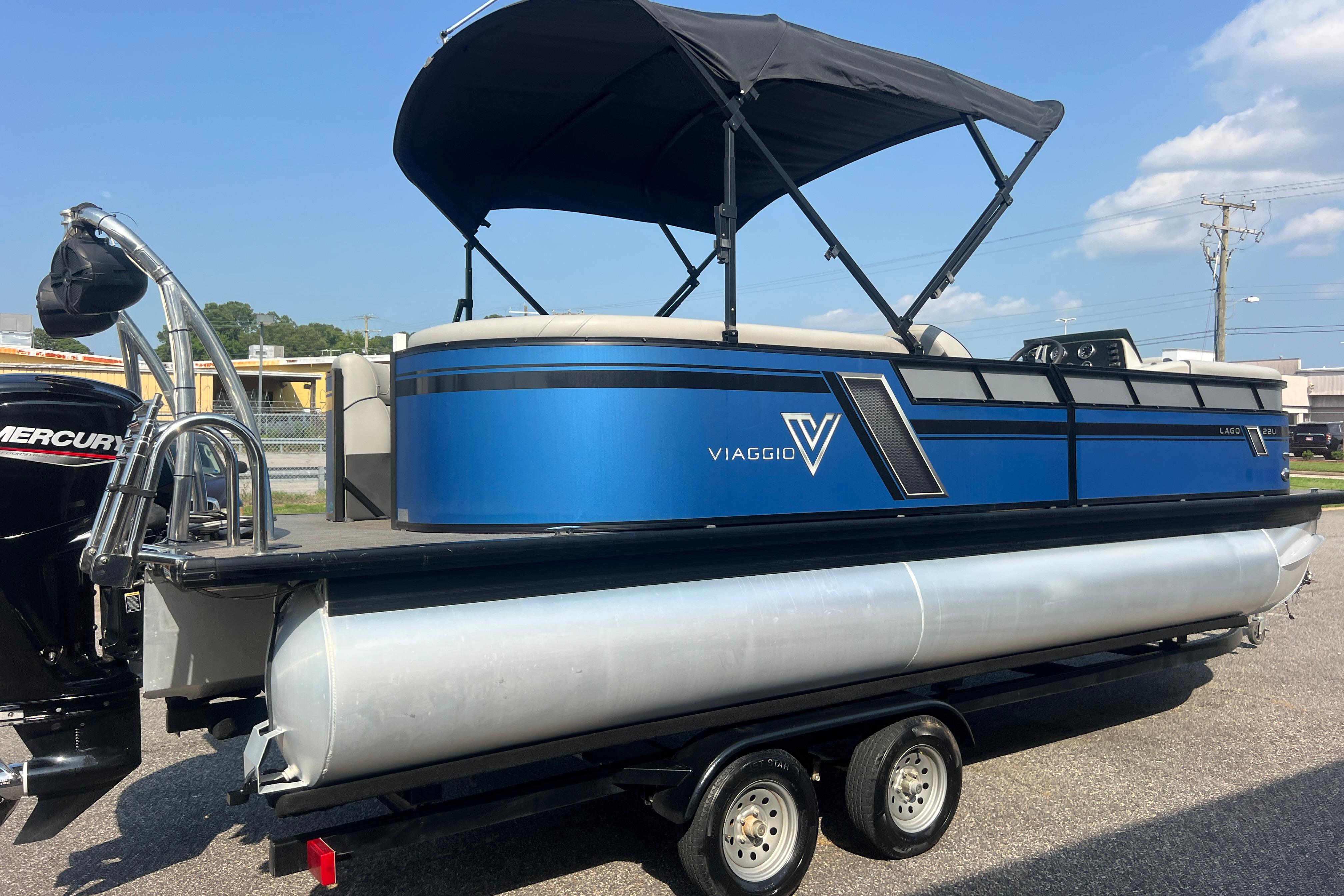 2022 Viaggio Lago V-U 22 pontoon boat with blue exterior and black canopy.