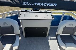 2026 Sun Tracker Fishin' Barge 20 DLX interior with seating and storage.