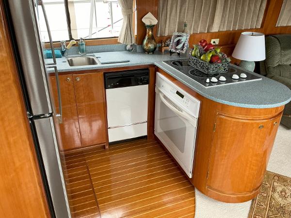 Kitchen area of 2000 Novatec Islander 55 yacht with modern appliances and wood finish.