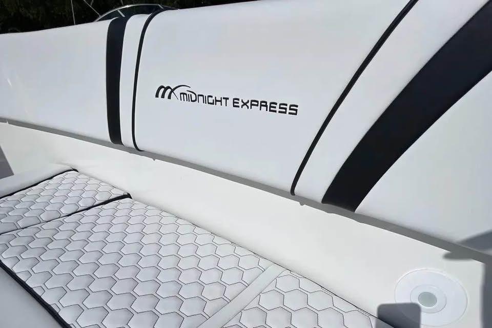 2009 Midnight Express 34 Open boat interior with sleek white seating and logo.