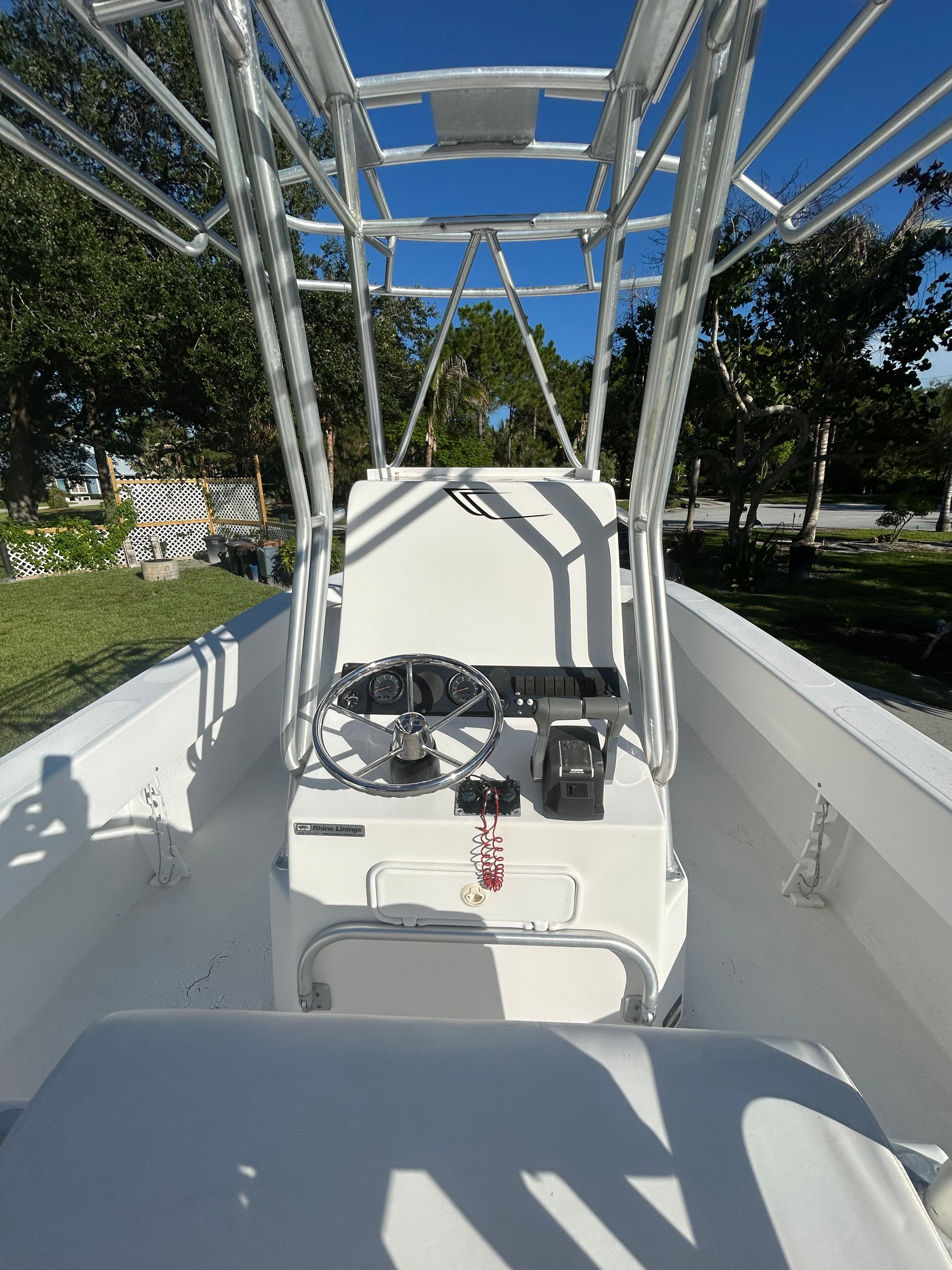 A 2007 Twin Vee 26 Center Console boat with an open helm and T-top.