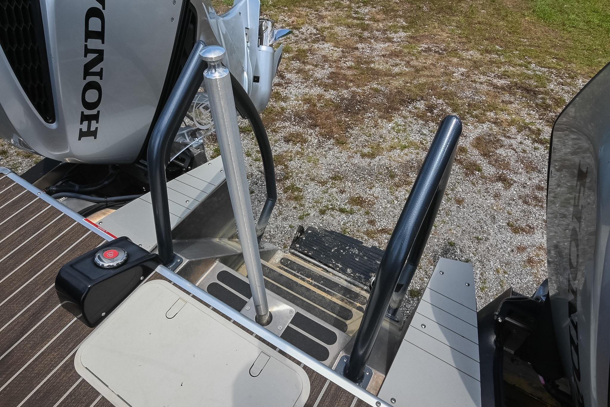 Rear view of 2023 Premier 270 Intrigue RF boat with Honda outboard motor.