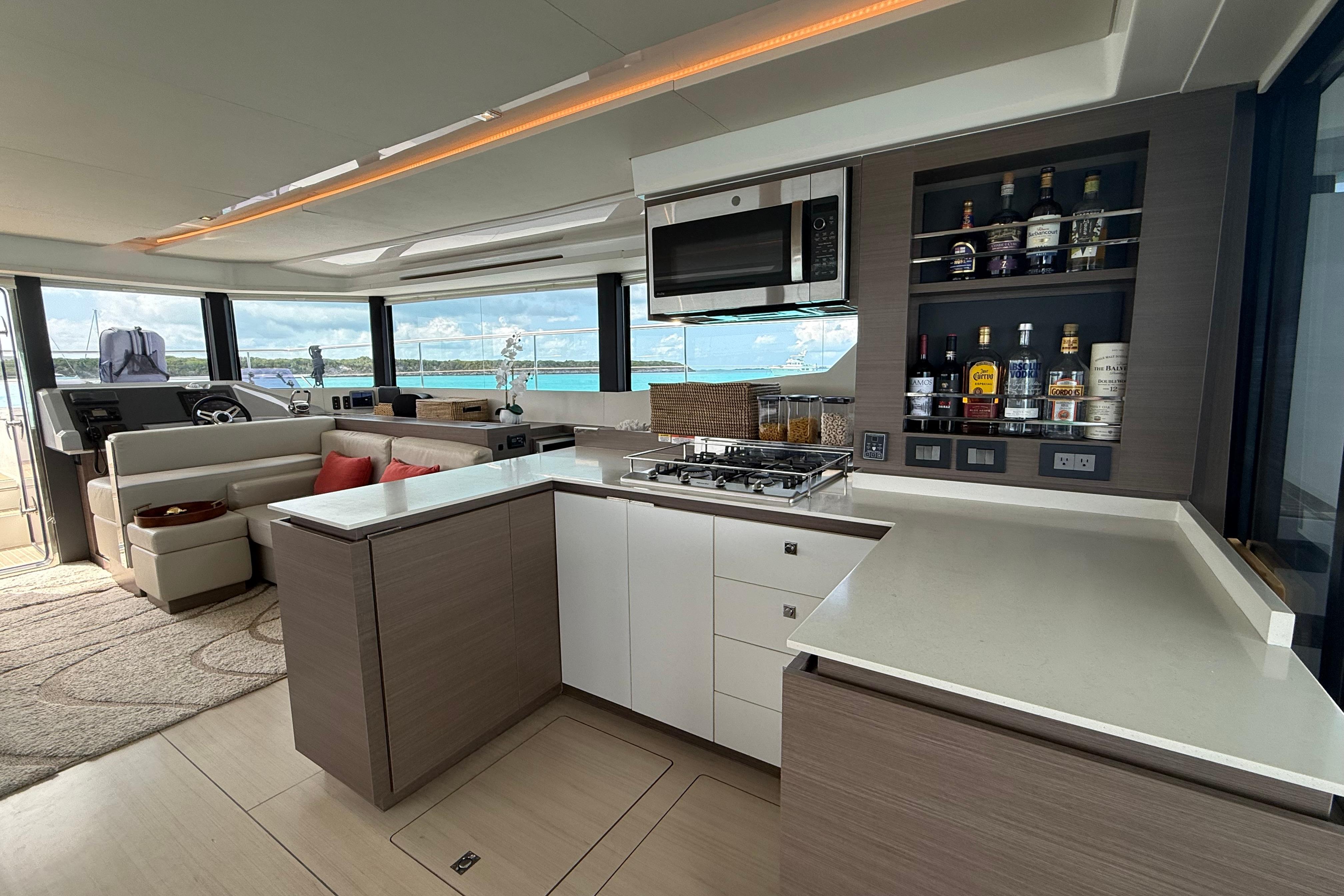 Luxurious interior of 2021 Leopard 53 Powercat yacht with modern kitchen and seating area.