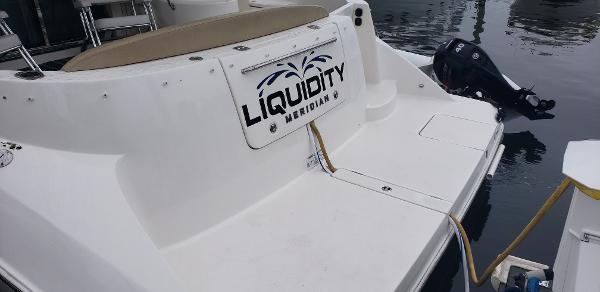 2010 Meridian 441 Sedan yacht named "Liquidity" docked at marina.