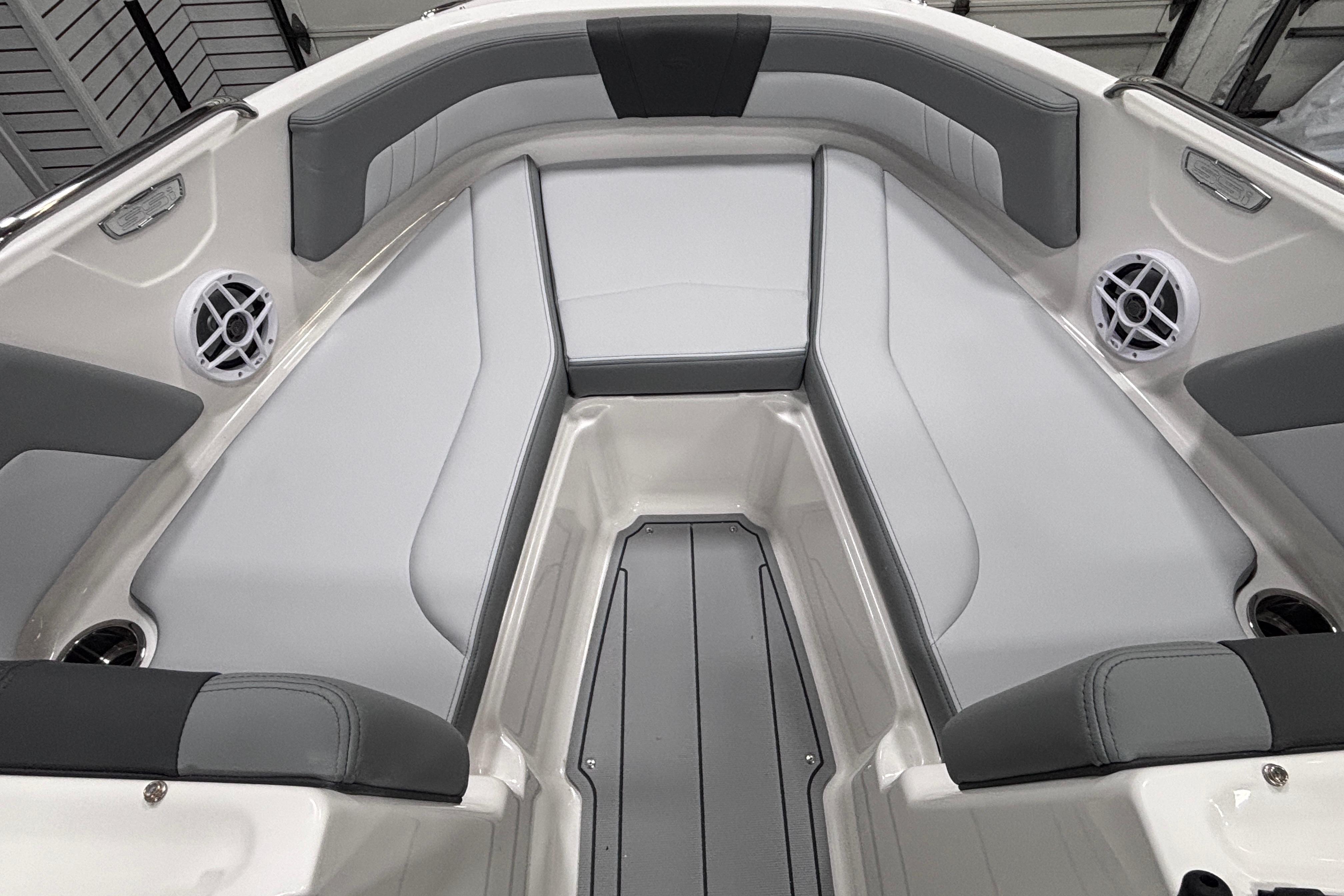 2026 Chaparral 21 SSi boat interior with gray and white seating, featuring built-in speakers.