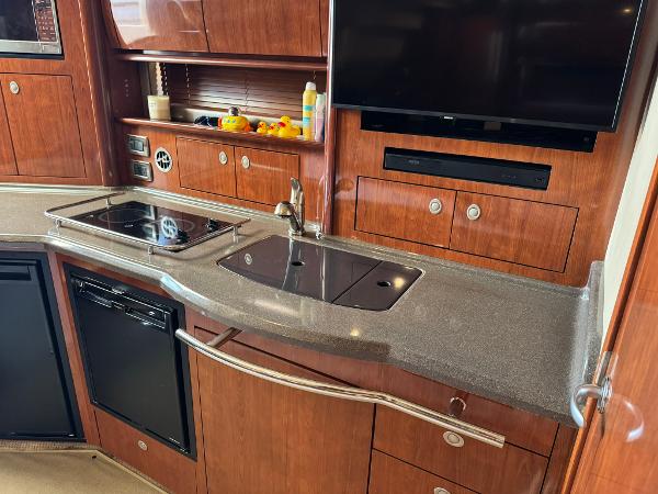 Luxurious kitchen area in 2004 Sea Ray 390 Sundancer yacht with modern amenities.