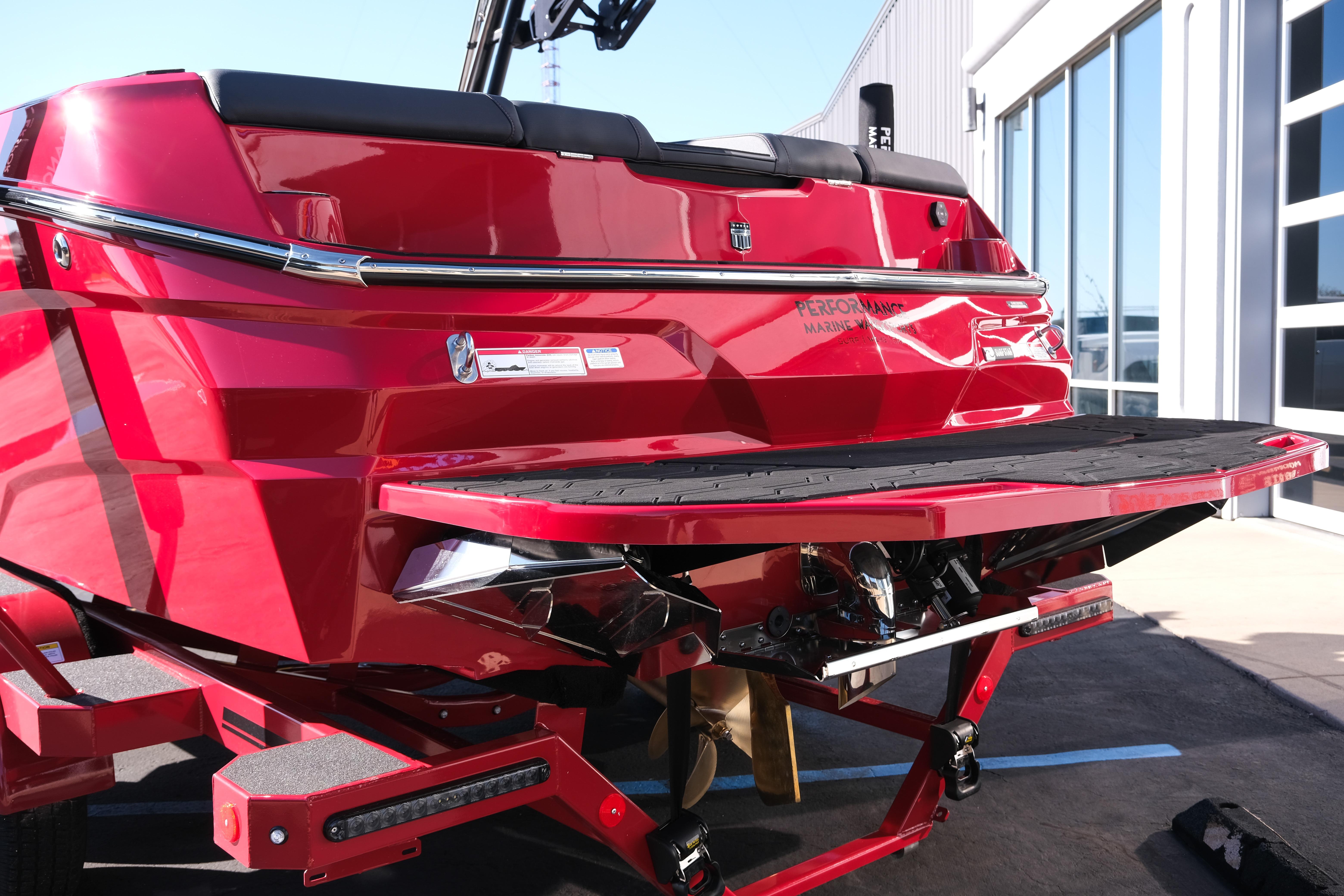 2026 MasterCraft NXT22 boat in vibrant red, rear view with swim platform.