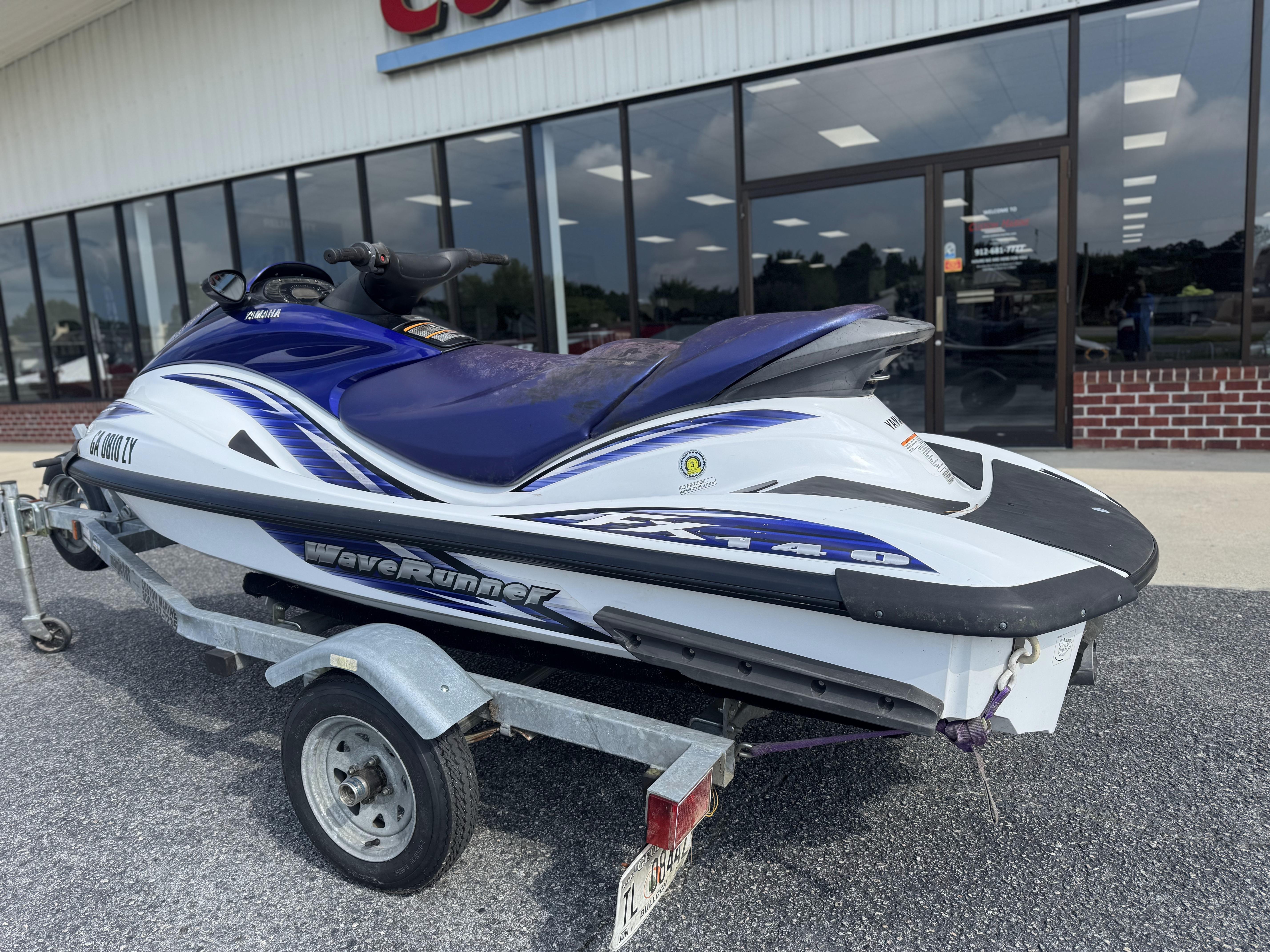 2003 Yamaha WaveRunner FX140 on trailer outside a store.