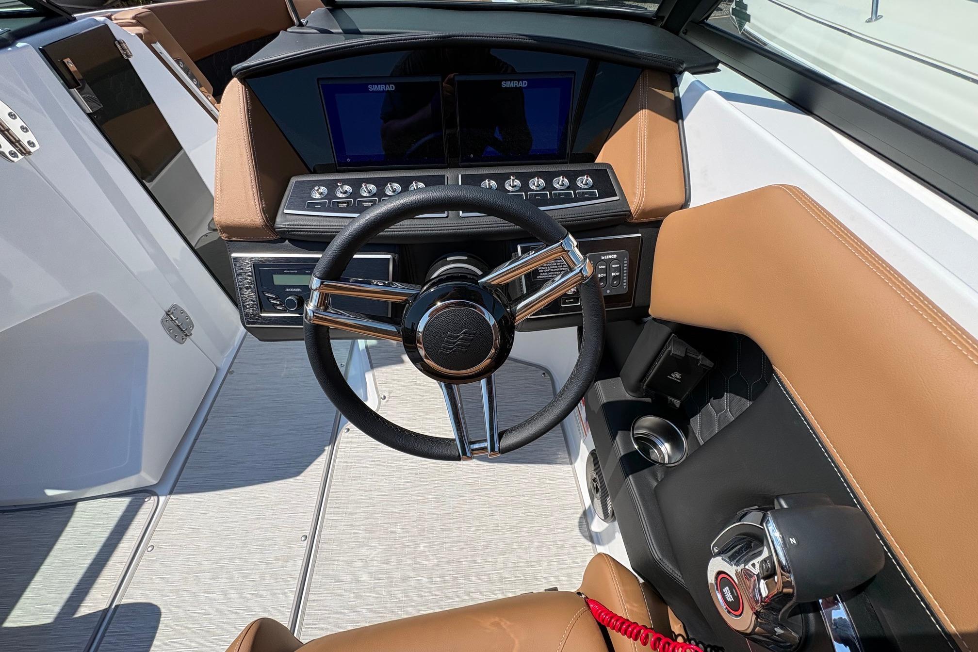 2026 Four Winns H6 boat cockpit with modern steering wheel and control panel.