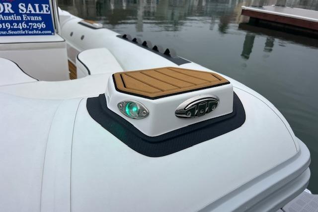 2023 Novurania Como 18 boat detail with green navigation light and wooden deck accent.