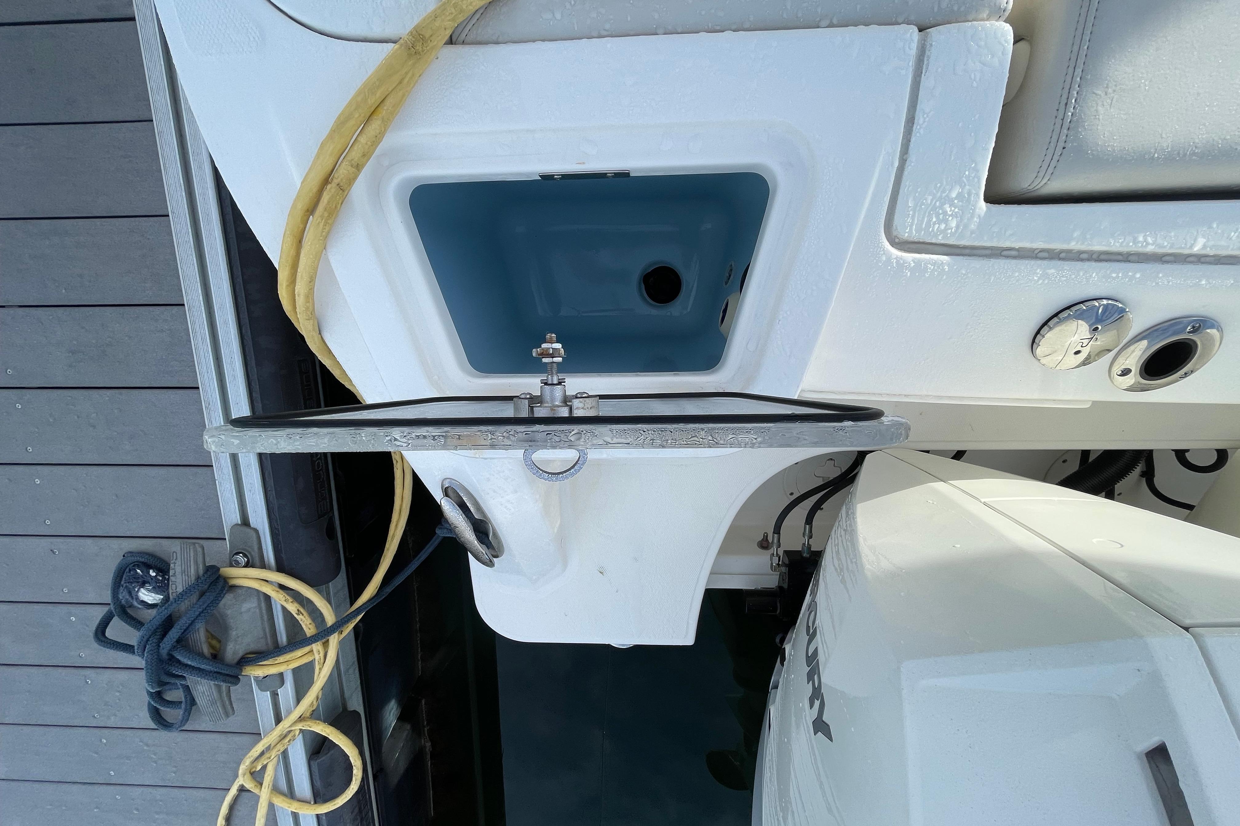 Boston Whaler 350 Realm 2022 boat stern with engine and dock ropes.