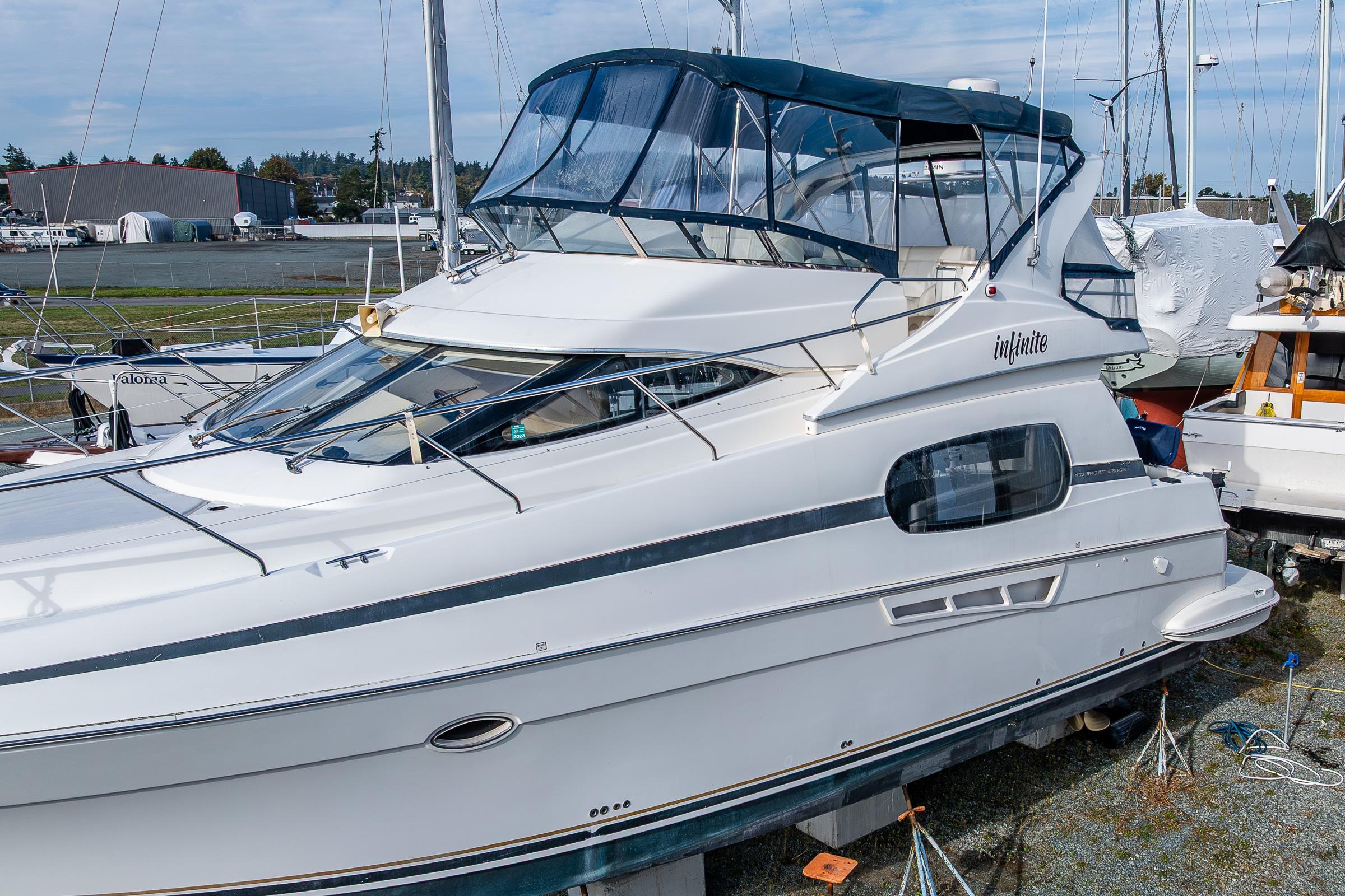 2001 Silverton 410 Sport Bridge yacht docked, featuring sleek design and spacious upper deck.