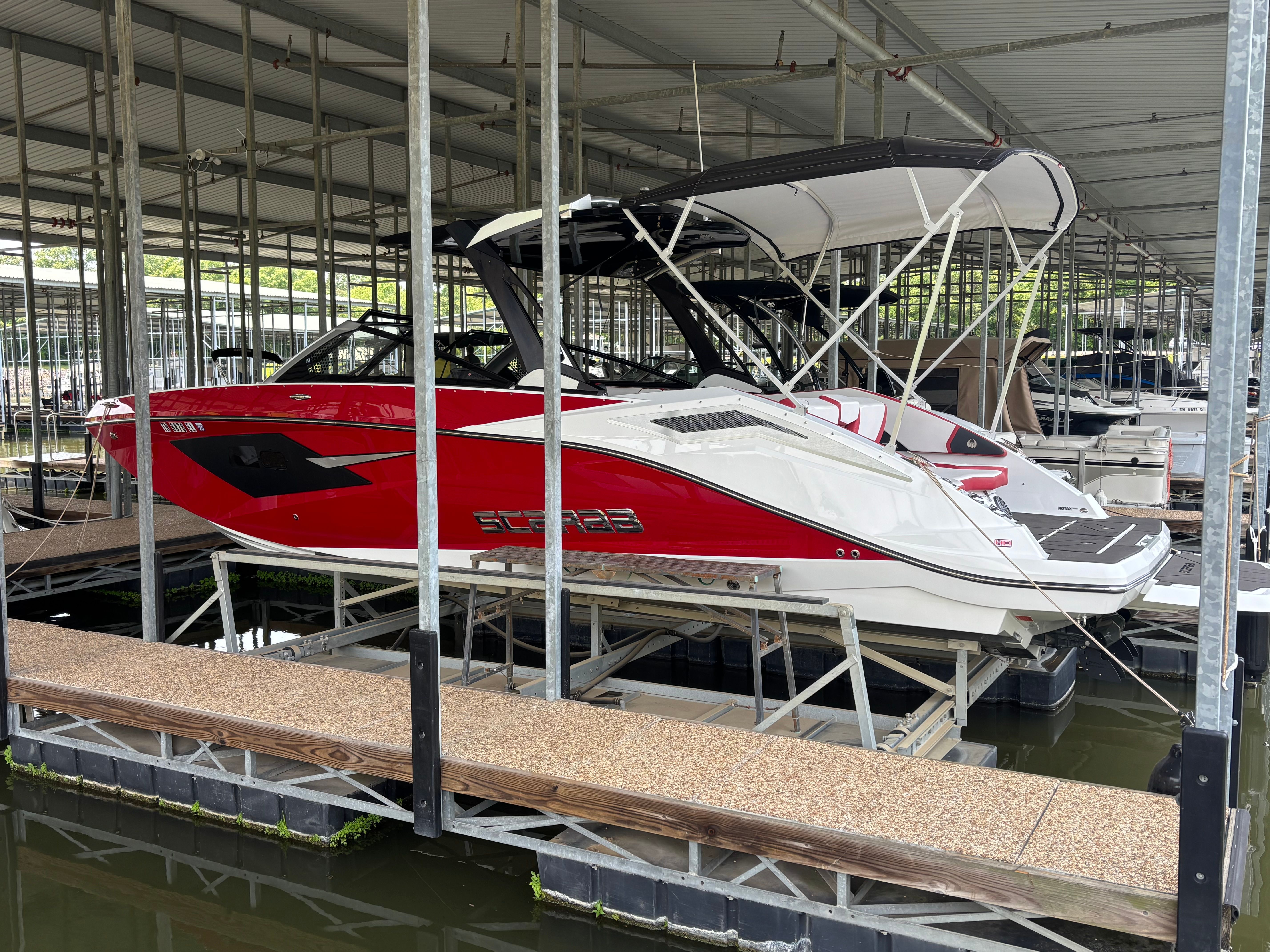 2021 Scarab 285 ID boat docked in marina.
