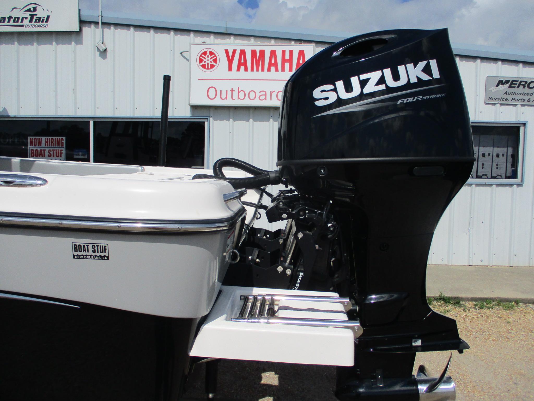 2024 Blue Wave 2800 Makaira boat with Suzuki outboard motor at dealership.