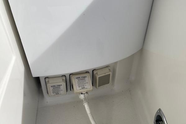 Power outlets on a 1999 Formula 400 Super Sport boat, featuring shore power connections.