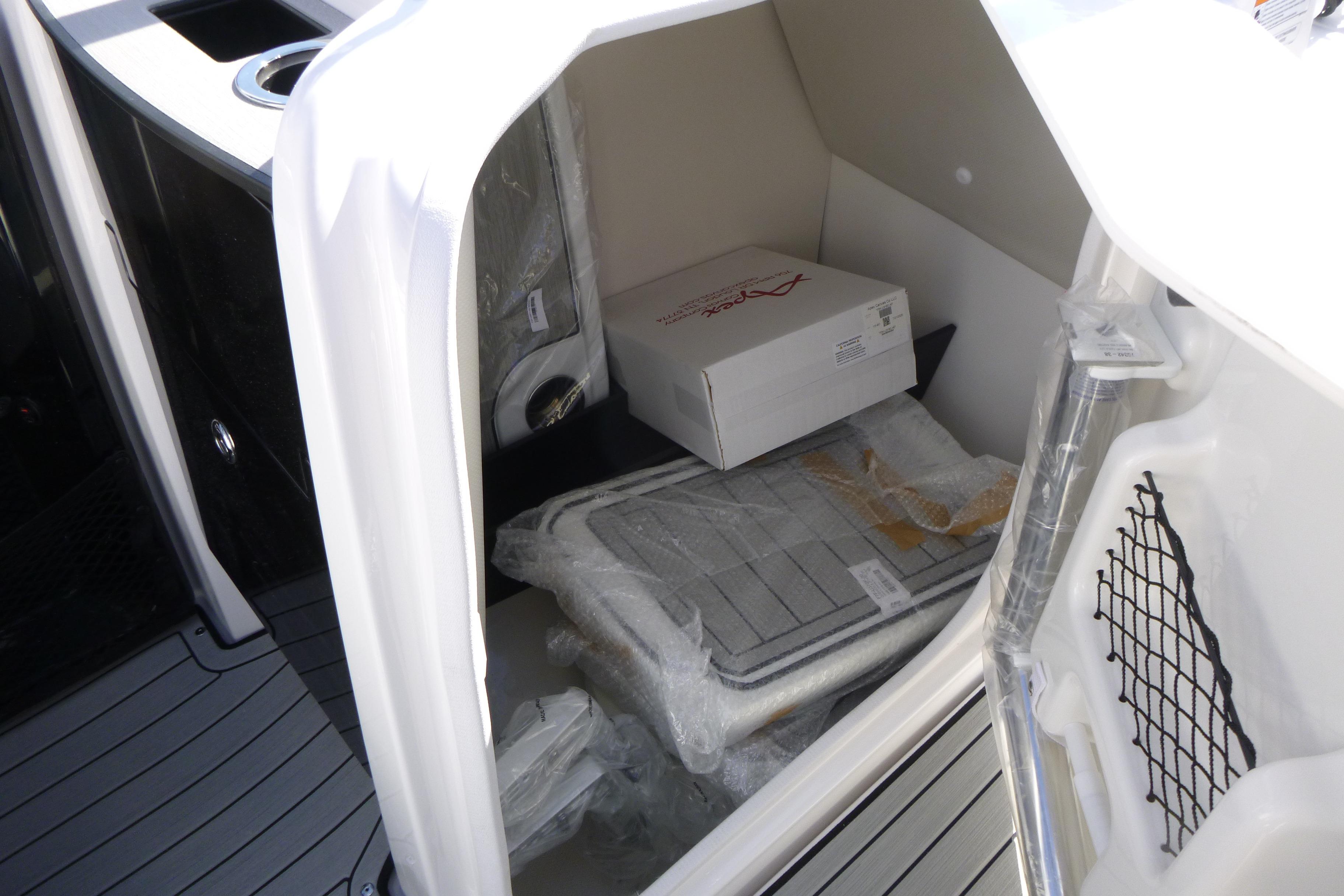 Storage compartment of 2026 Yamaha Boats 252SD, featuring organized interior space.