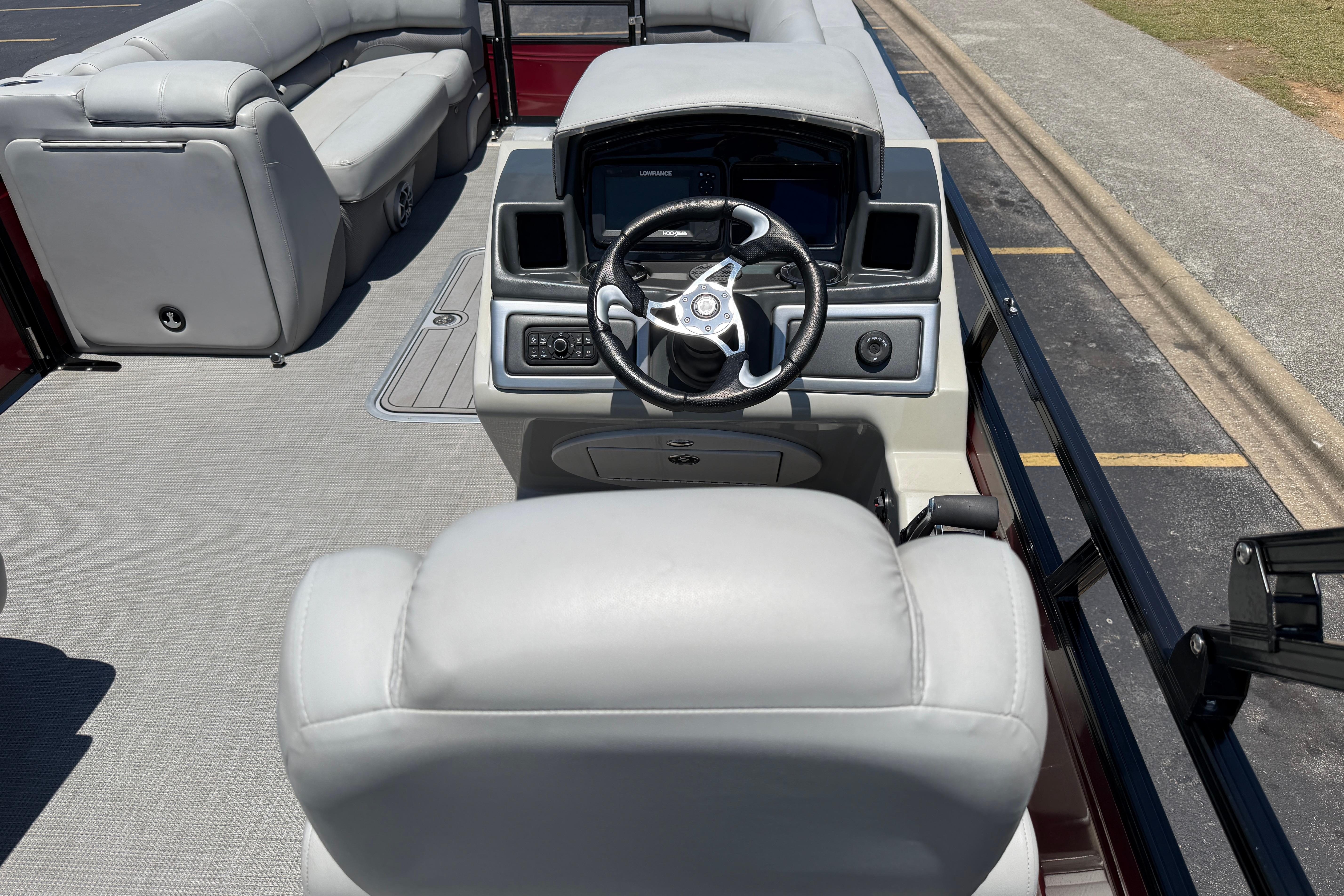 2024 Regency R250DL3 boat interior with steering console and plush seating.