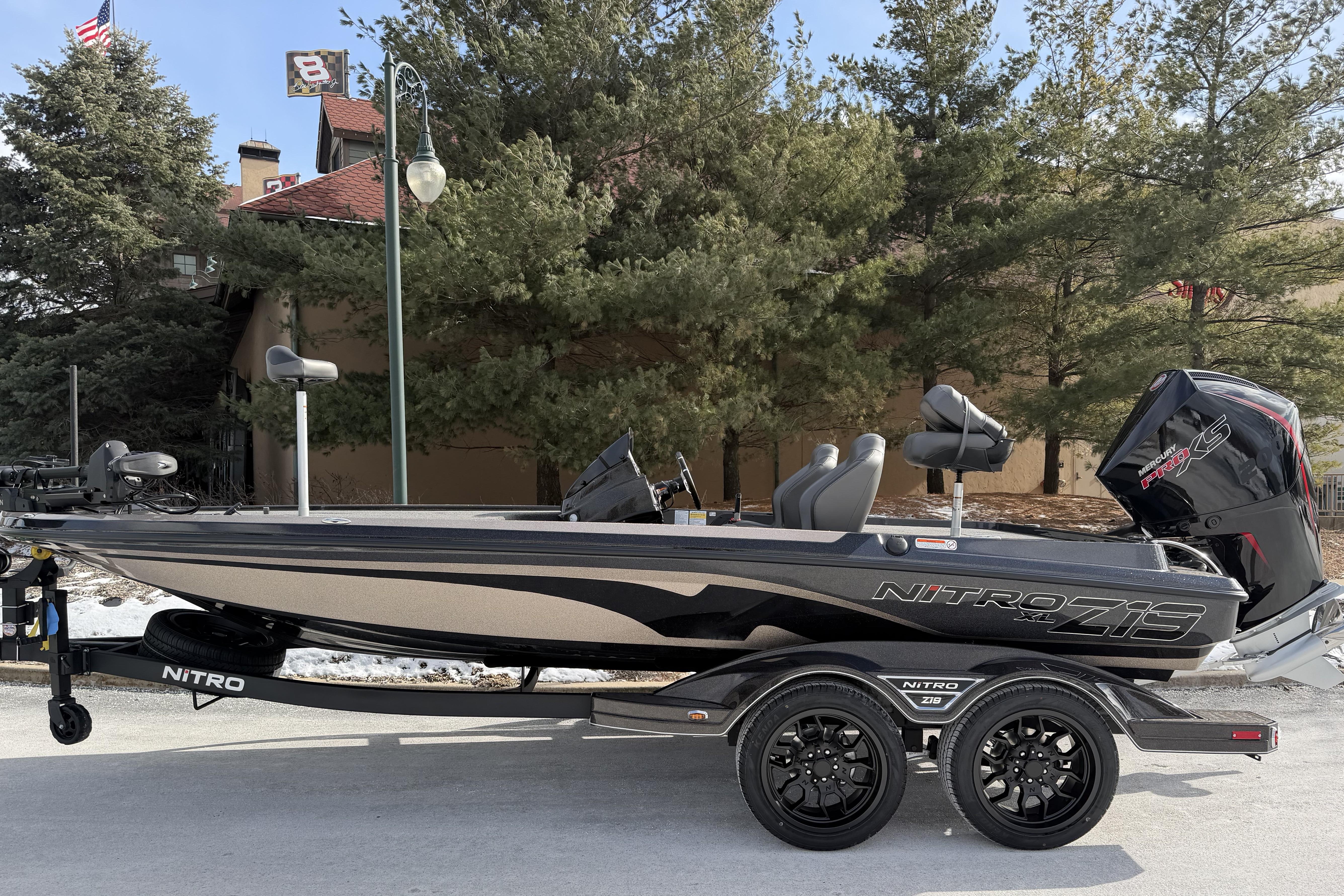 2026 Nitro Z19 XL Pro boat on trailer, parked outdoors with trees in background.