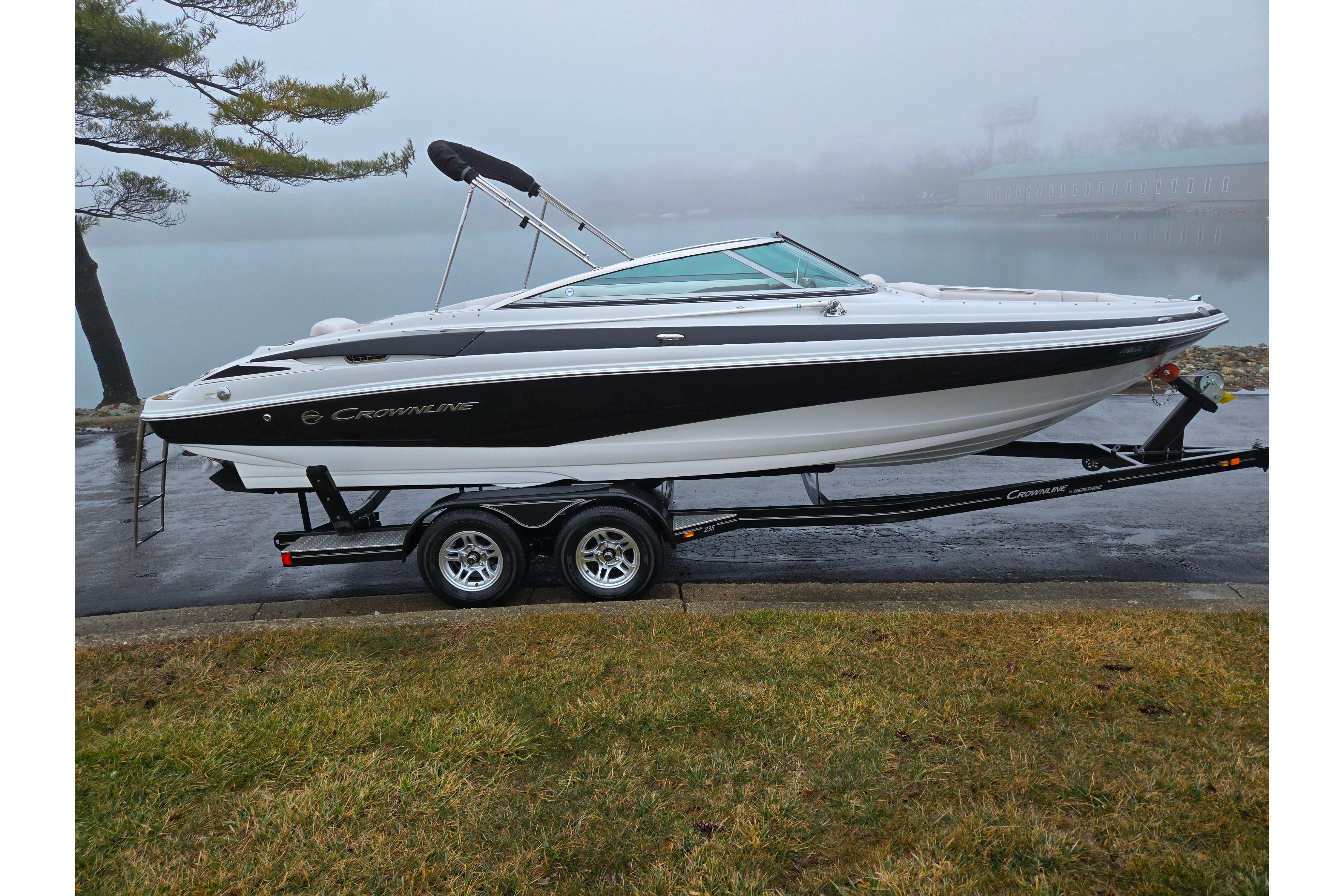 2012 Crownline 235 SS boat on trailer by a foggy lake.