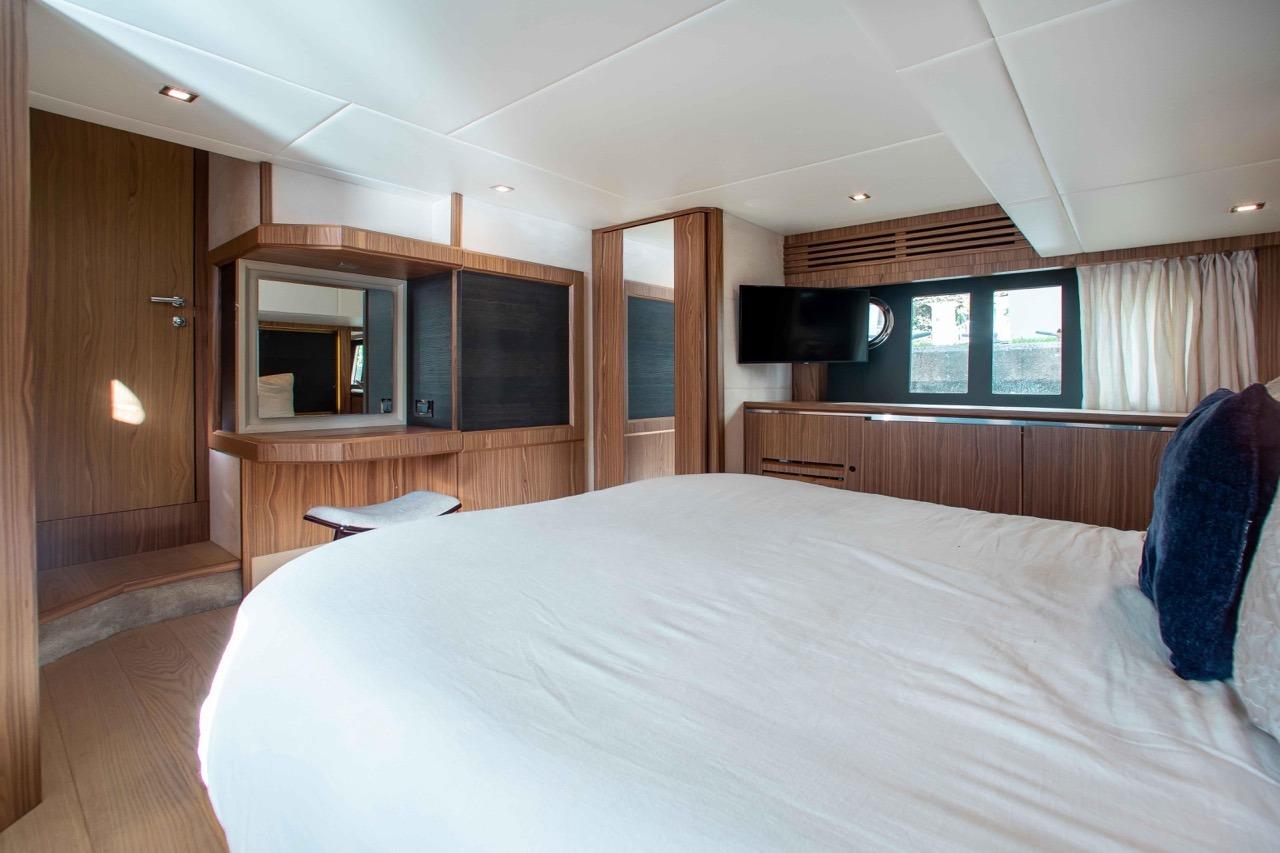 Luxurious cabin interior of 2015 Absolute 56 FLY yacht with modern wood finishes.