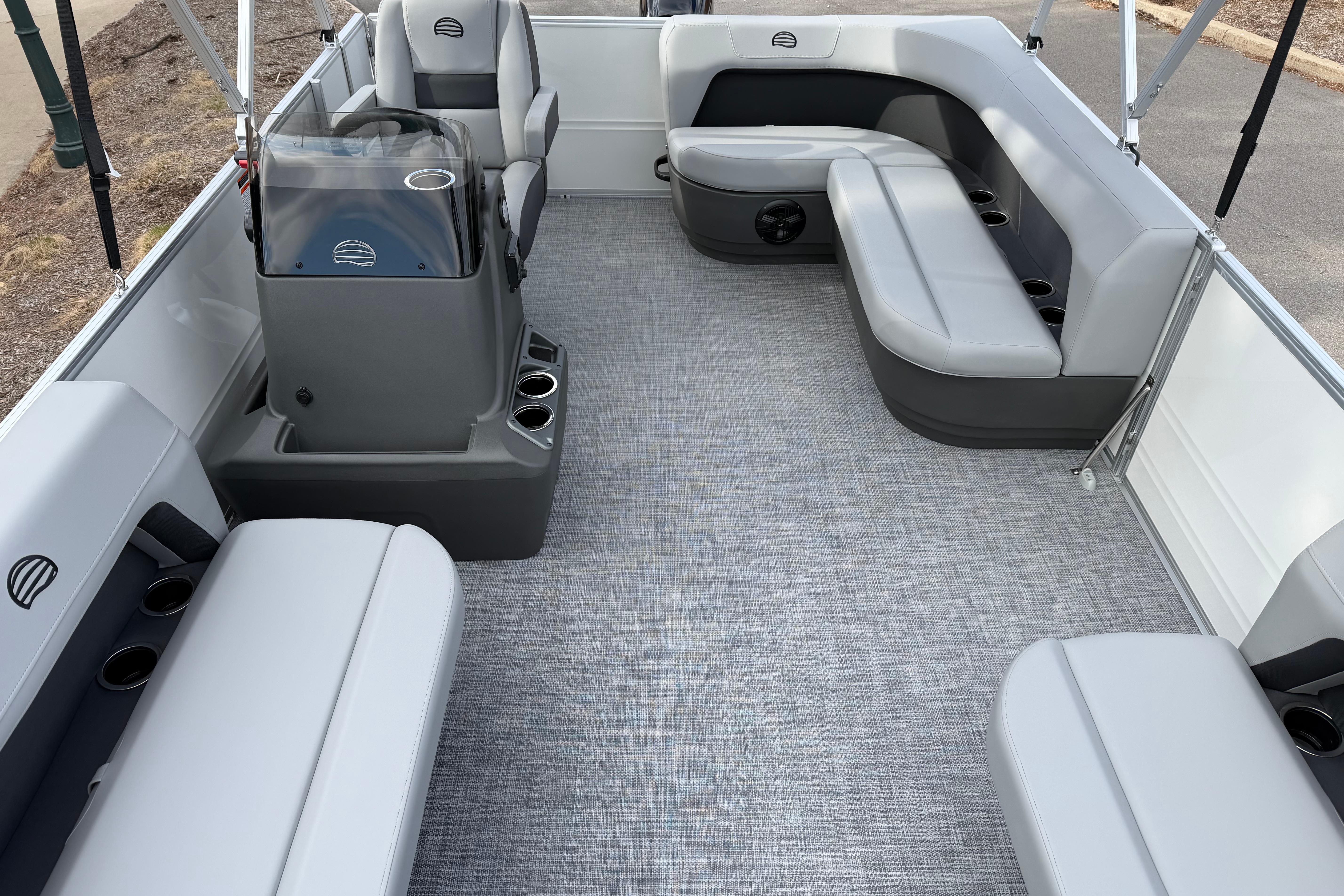 2026 Sun Tracker Party Barge 16 DLX interior with gray seating and modern helm.