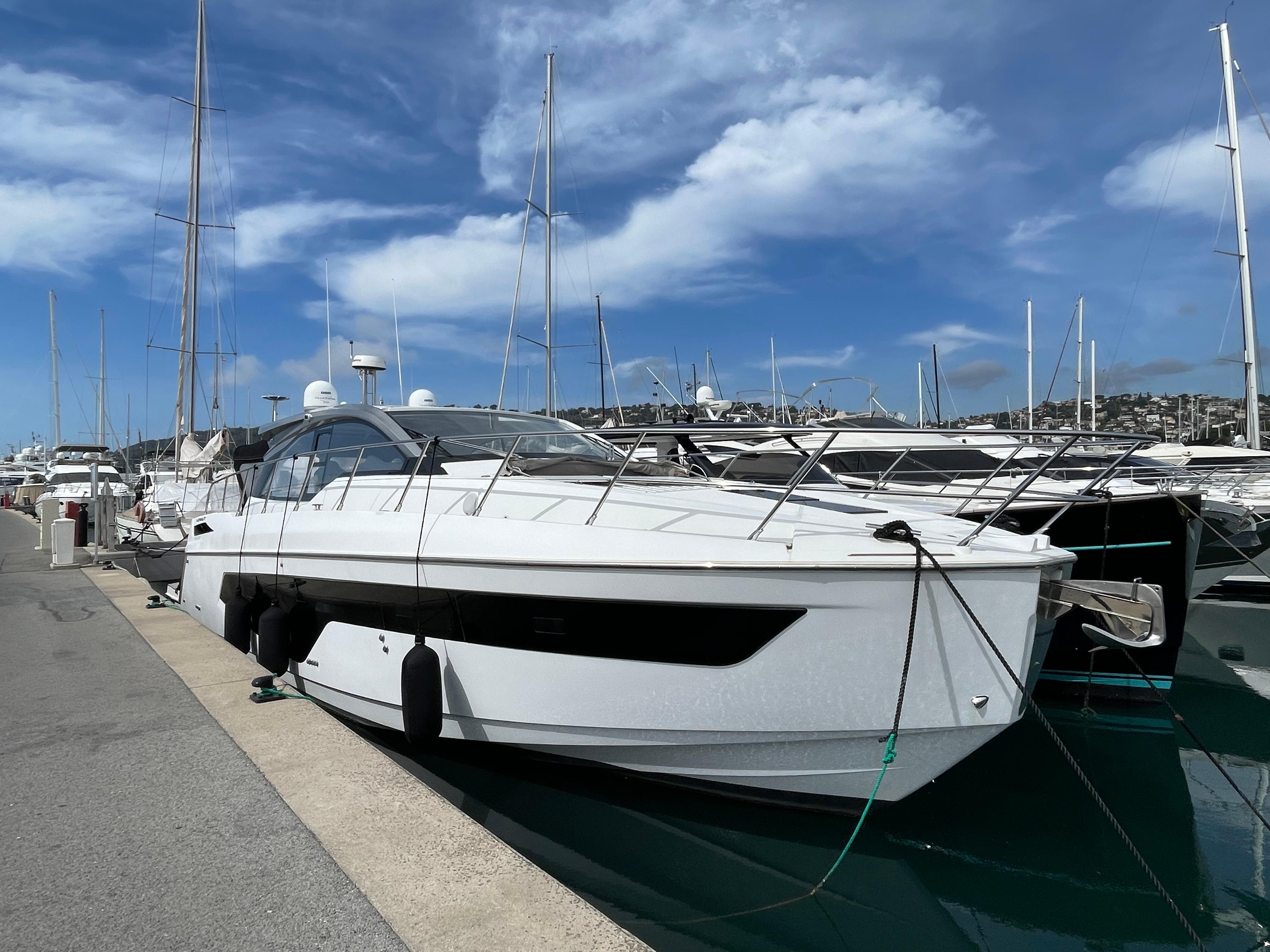 Azimut Atlantis 51 yacht docked at marina, 2018 model, under a clear blue sky.