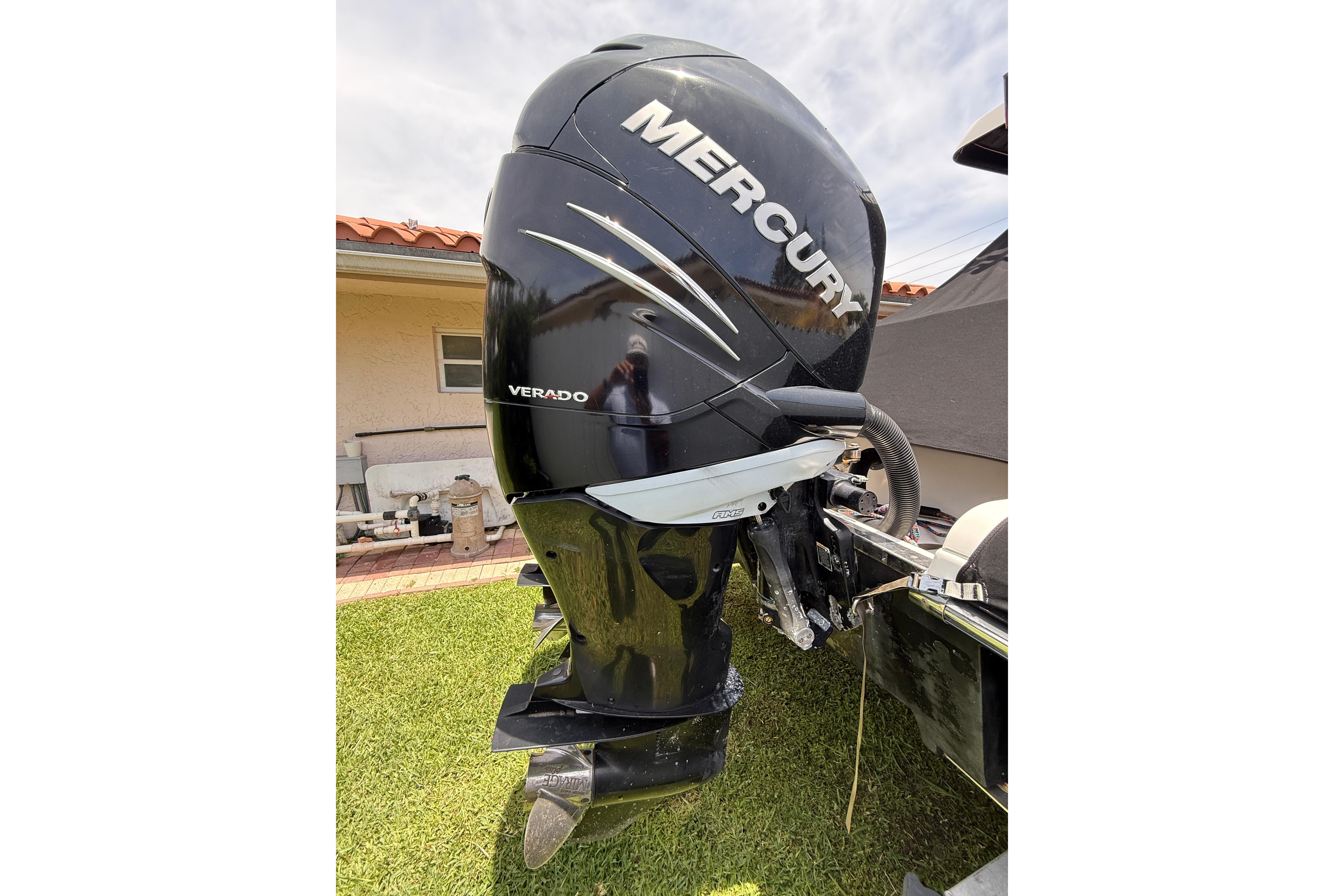 2015 Blackwood 27 boat with Mercury Verado outboard motor in a yard setting.