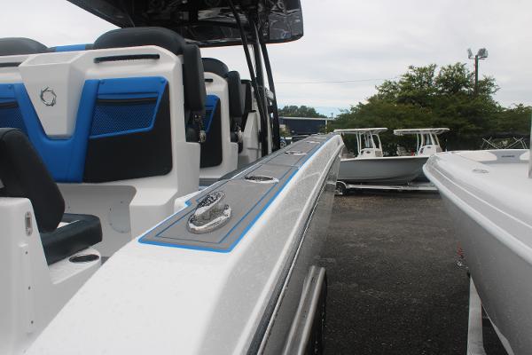 2024 Fountain 34 SC boat with sleek design and modern seating, docked outdoors.