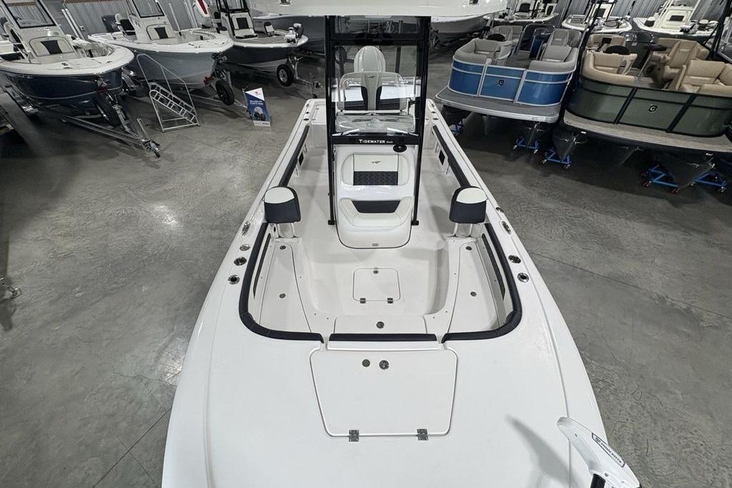 2026 Tidewater 2300 Carolina Bay boat interior in showroom, featuring spacious deck and seating.