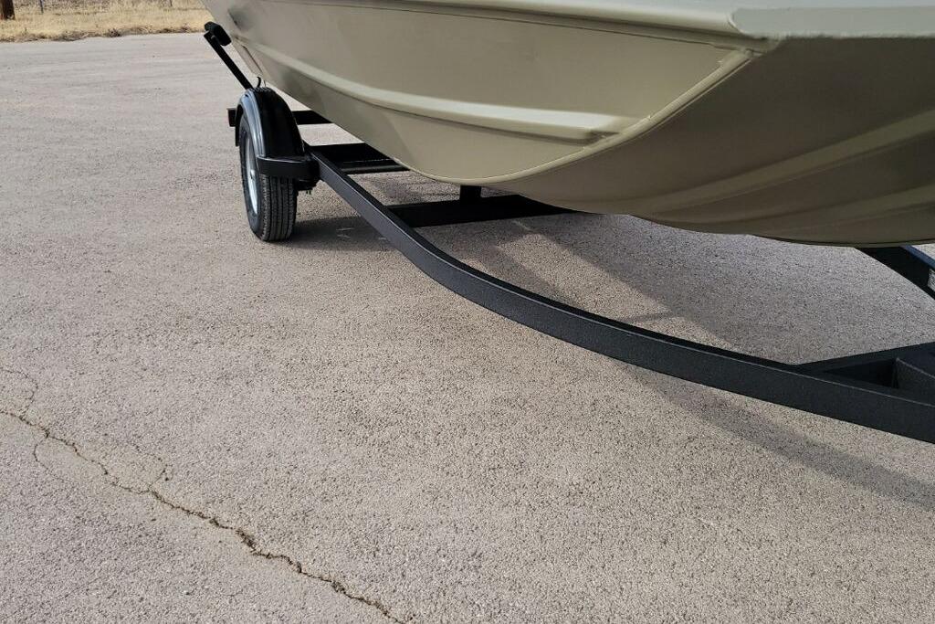2026 Tracker Grizzly 1754 SC boat on trailer, parked on pavement.
