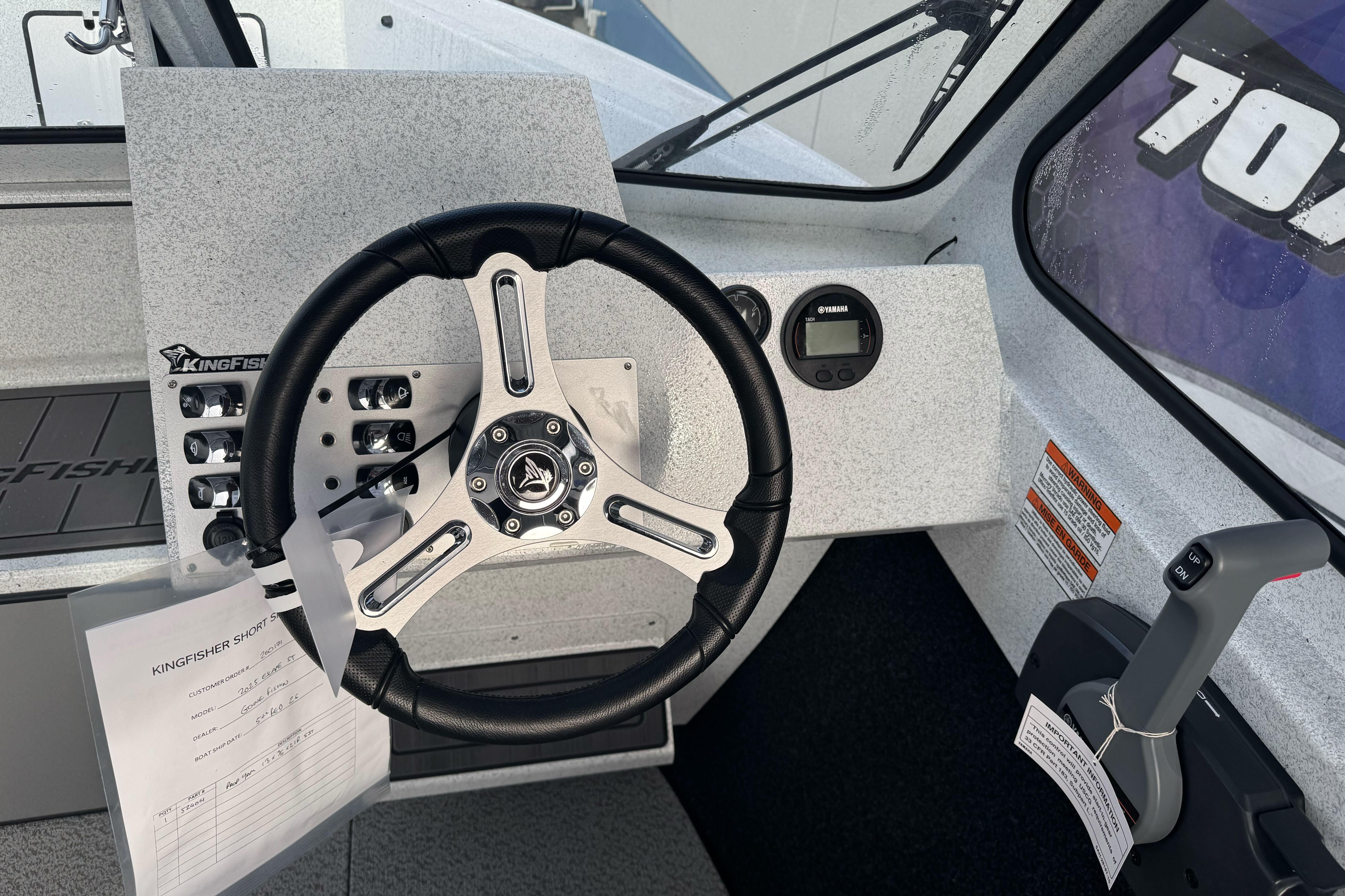 Steering console of 2026 KingFisher 2025 Escape boat with controls and gauges.
