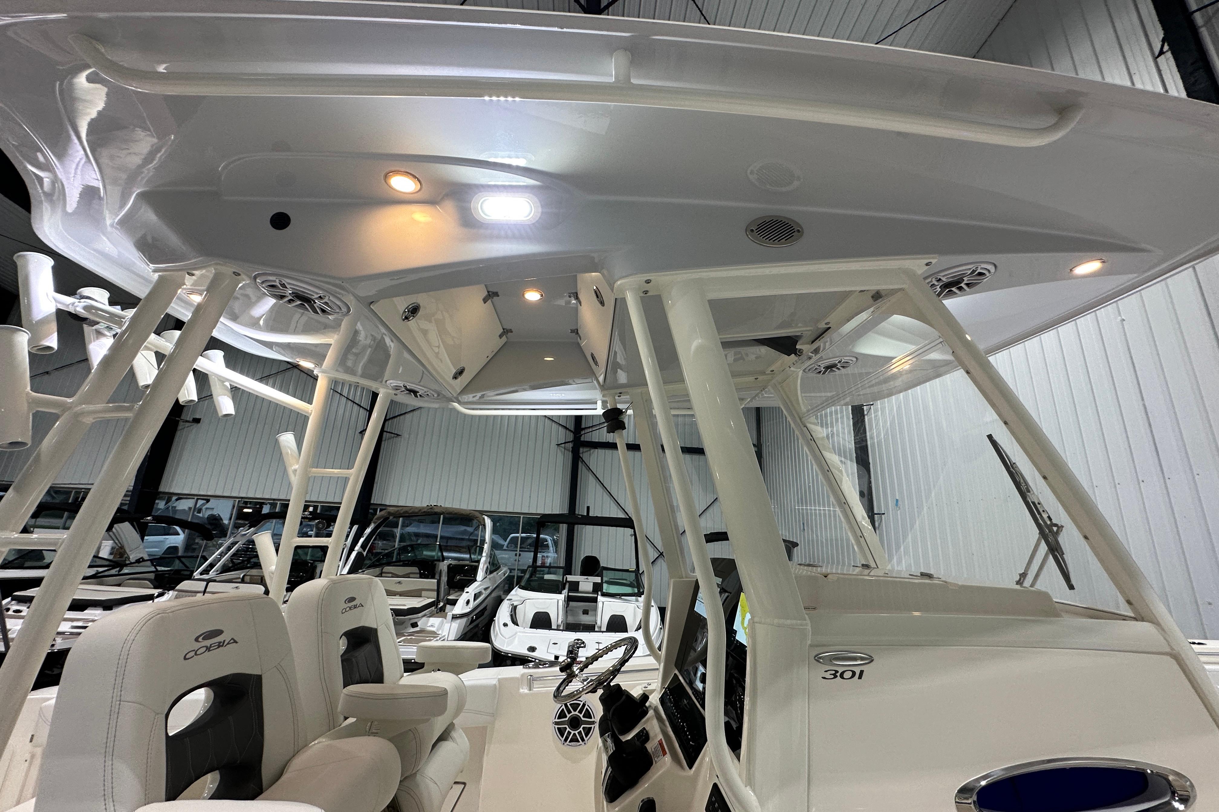 2024 Cobia 301 Center Console boat interior with seating and overhead lighting.