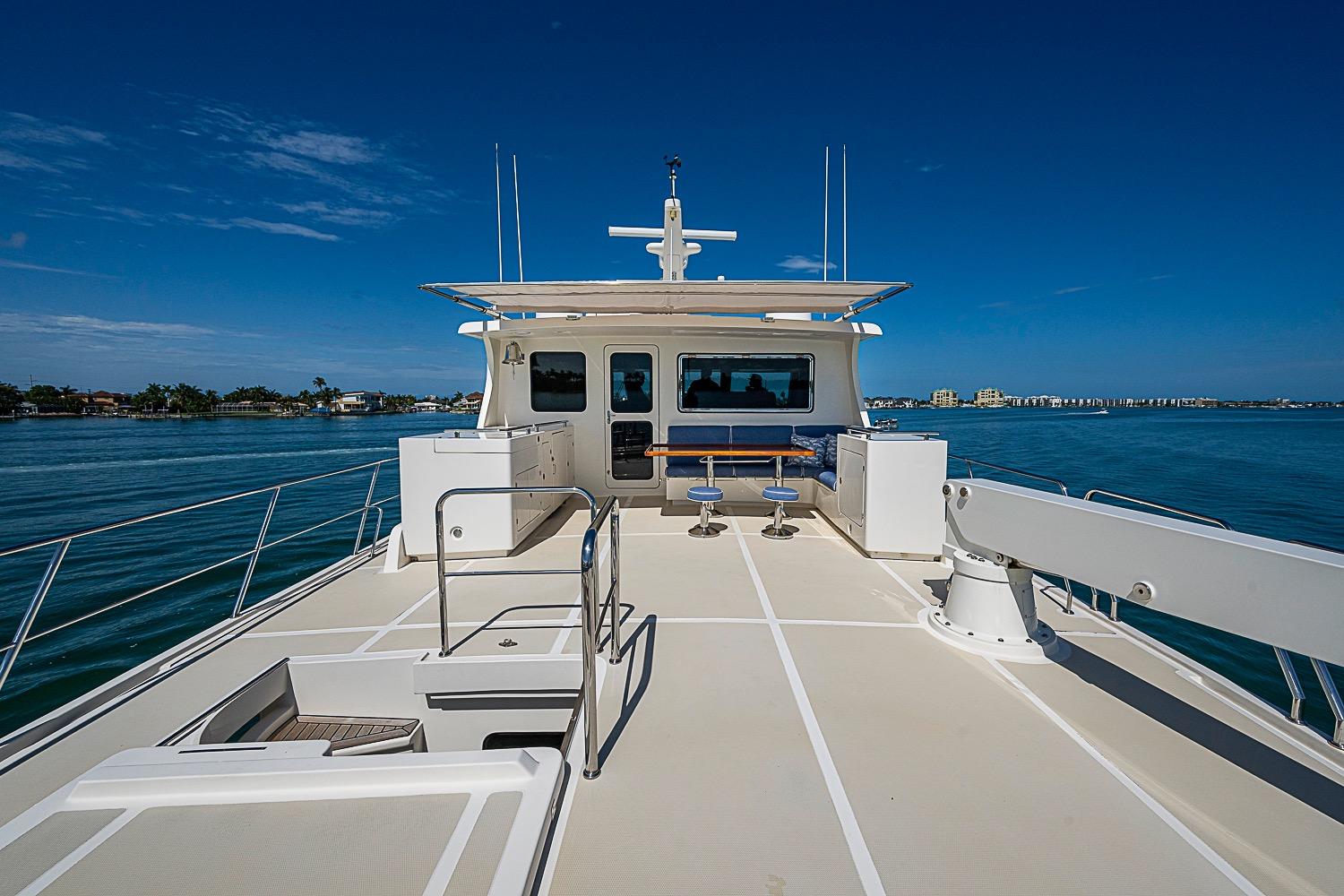 2014 Marlow 80 Explorer yacht deck with ocean view and seating area.
