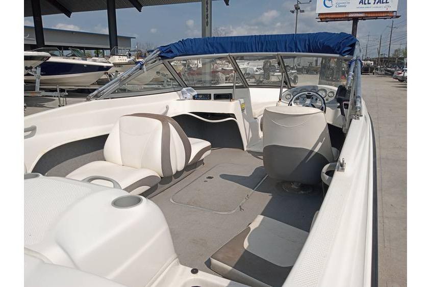 2008 Bayliner 175 boat interior with seating and steering wheel, parked outdoors.
