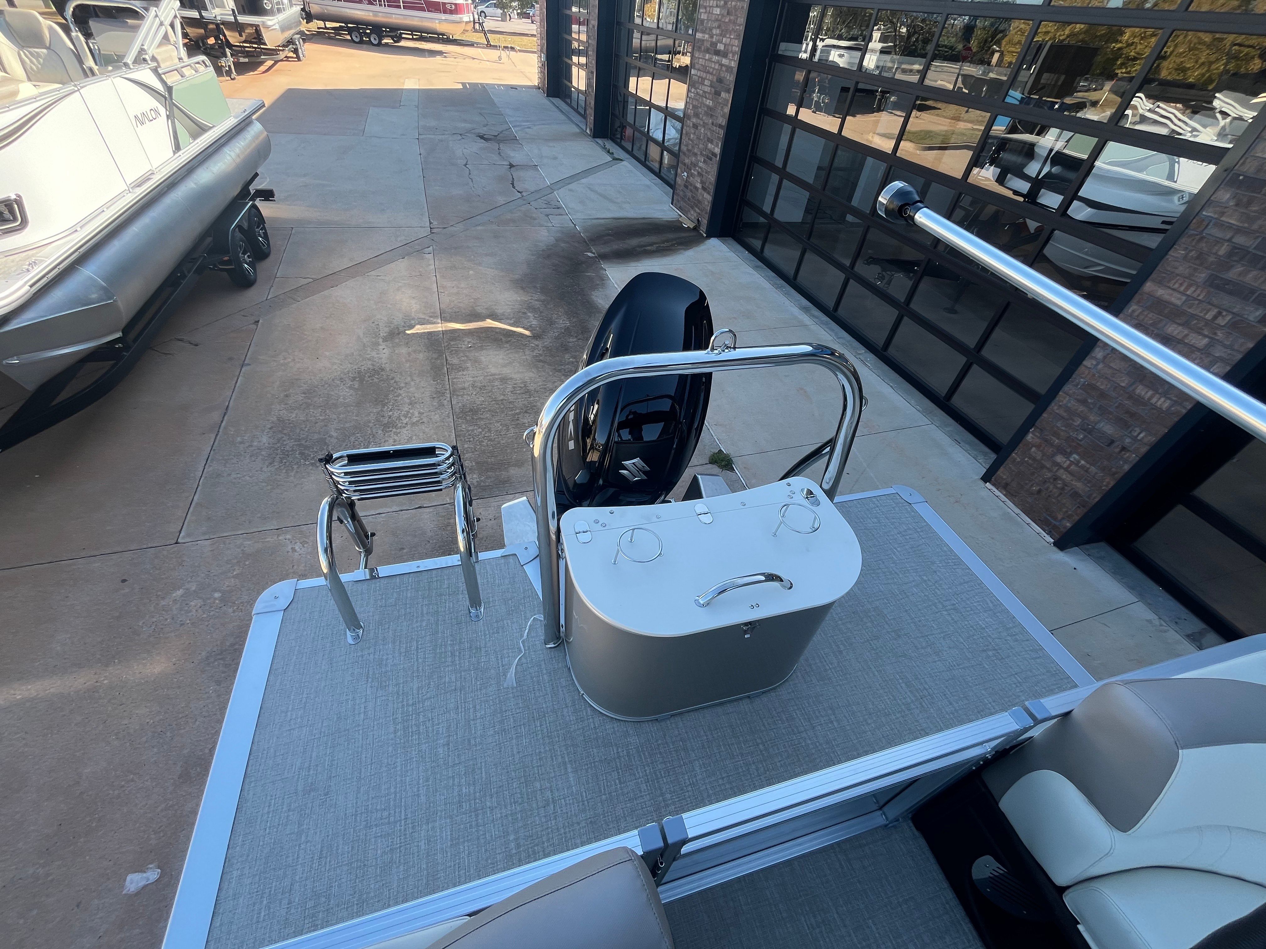 2026 Tahoe 2385 LTZ Quad Lounger boat with motor and ladder.
