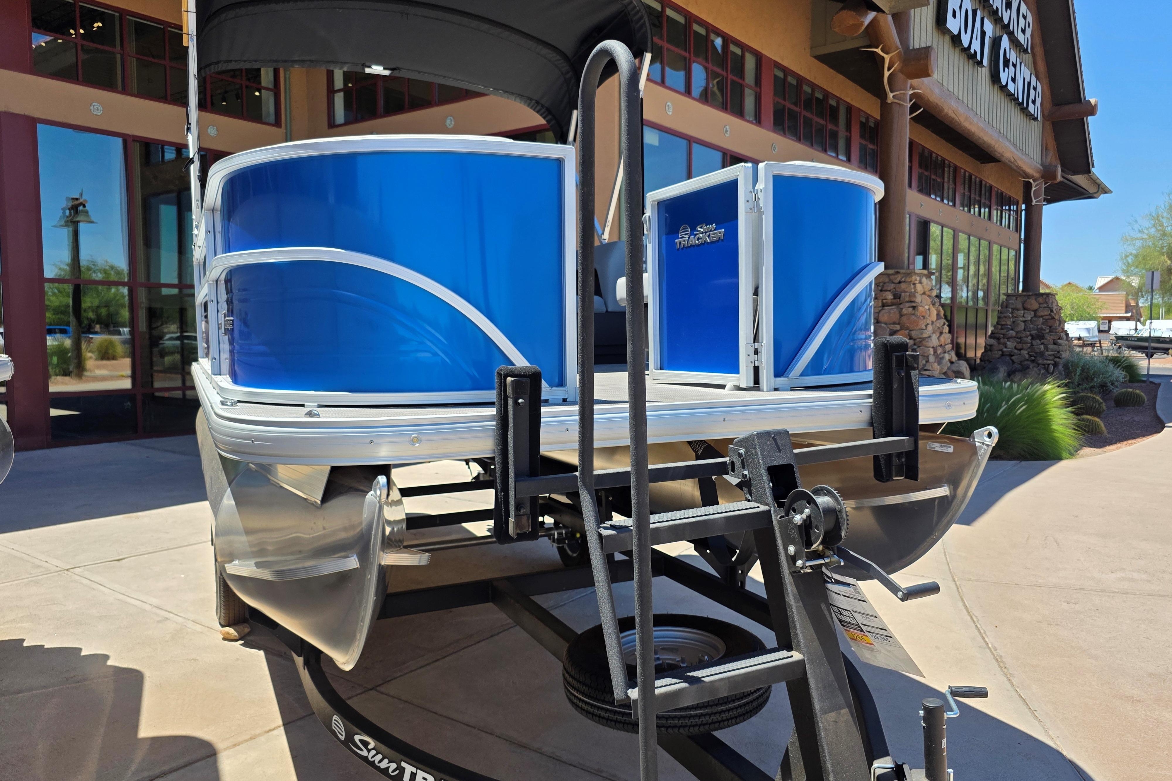 2026 Sun Tracker Party Barge 16 DLX pontoon boat displayed at a boat center.
