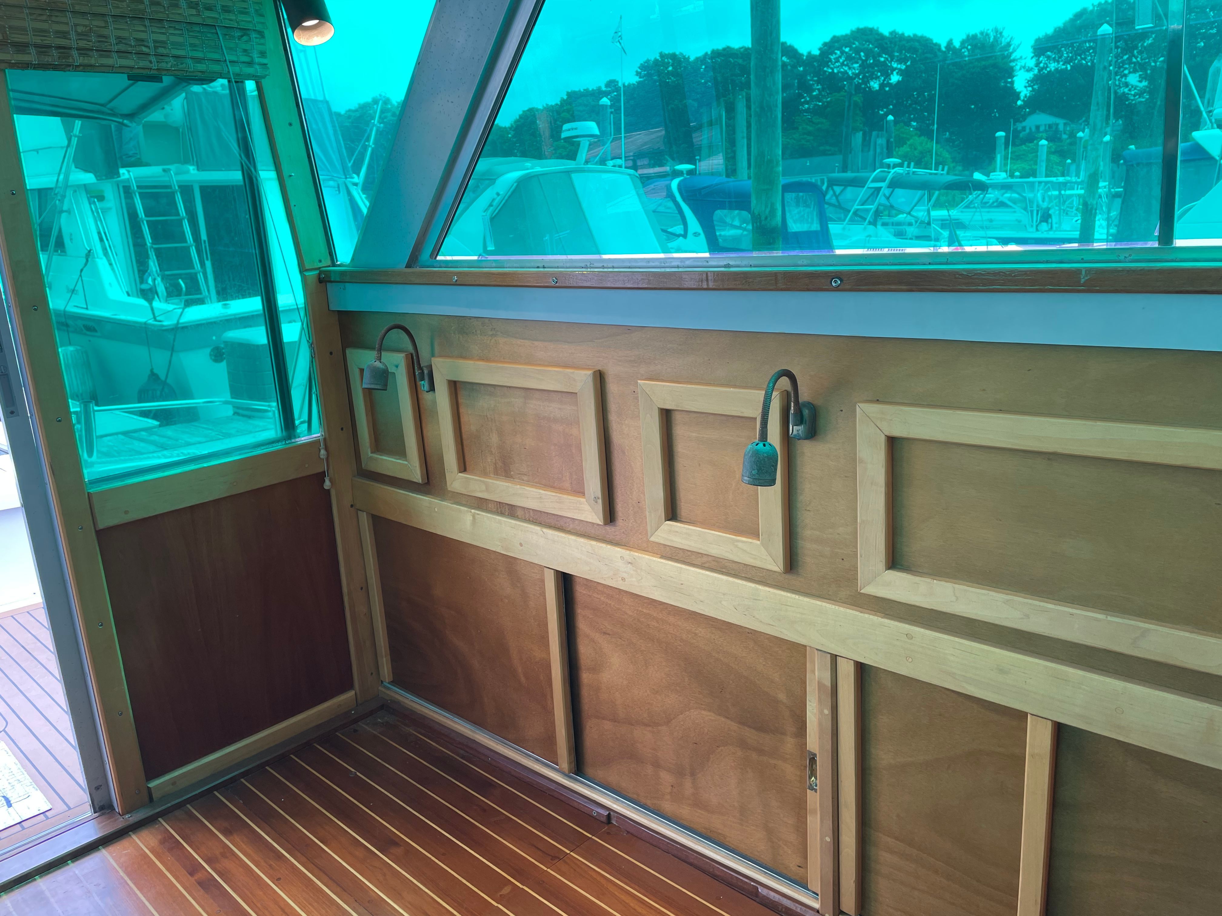 Interior of a 1969 Bertram Caribe with wooden walls and windows.