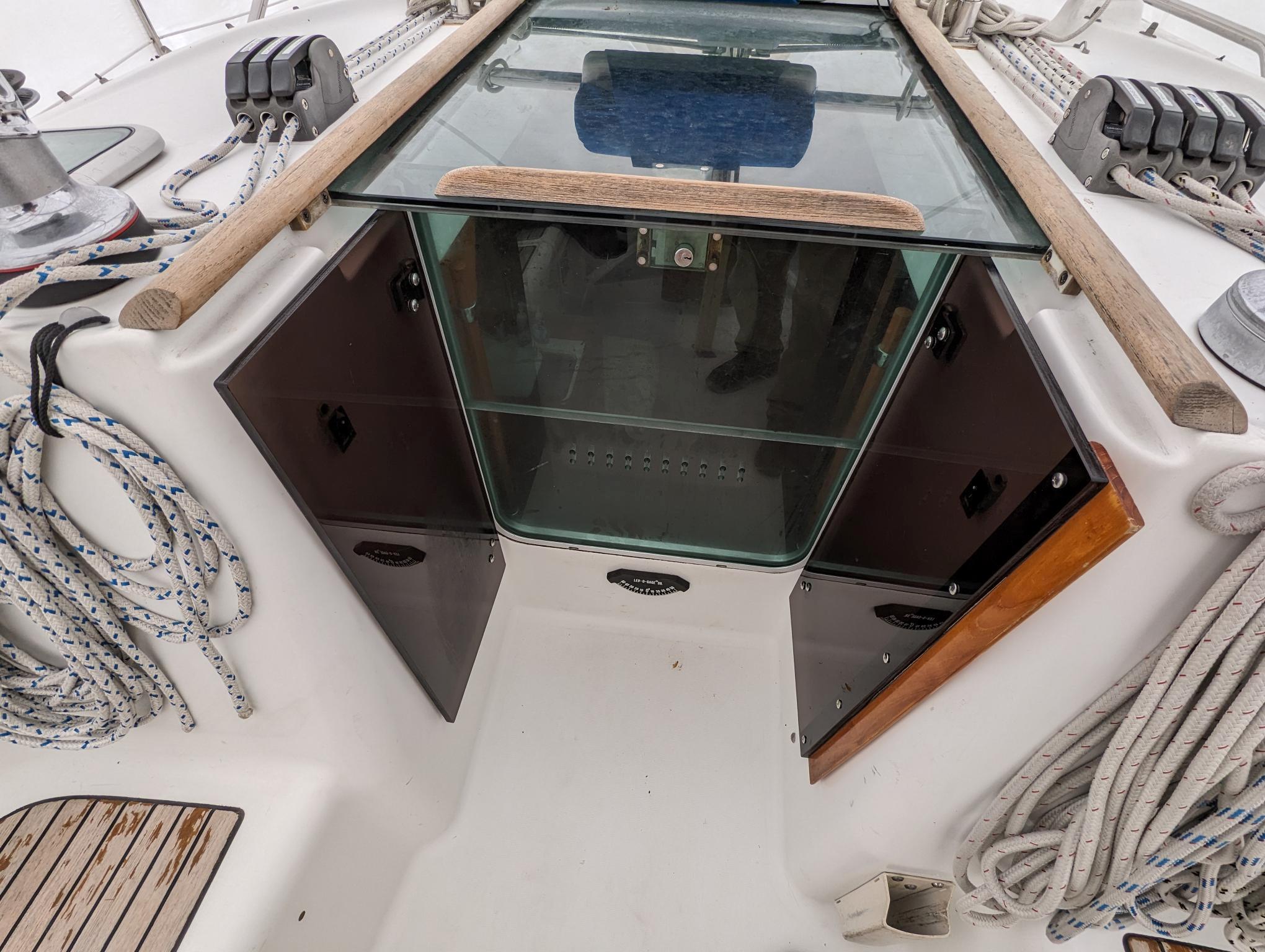 Beneteau 393 sailboat cockpit with open hatch, ropes, and winches, 2005 model.
