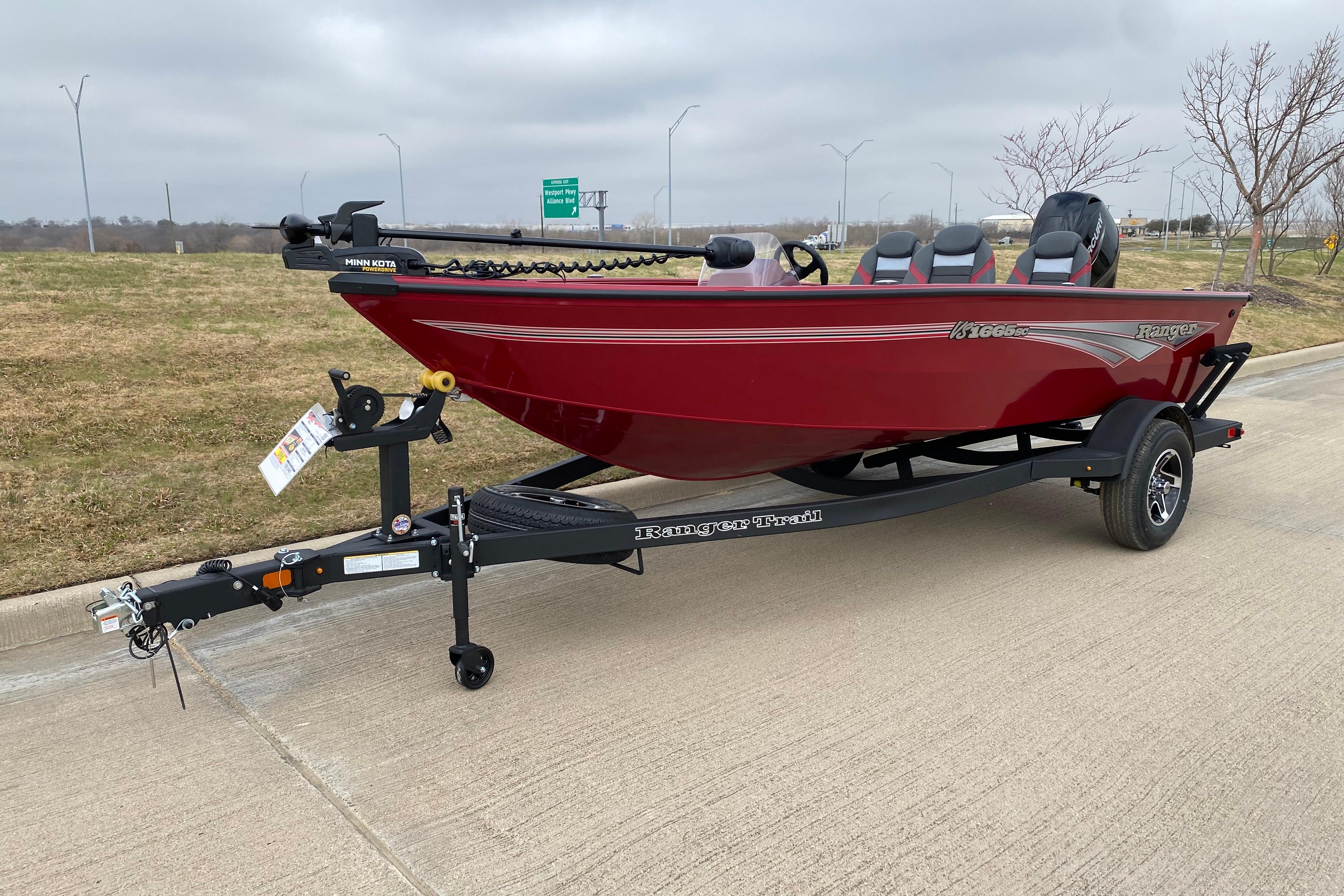 2026 Ranger VS1665SC boat on trailer, red exterior, parked on concrete road.
