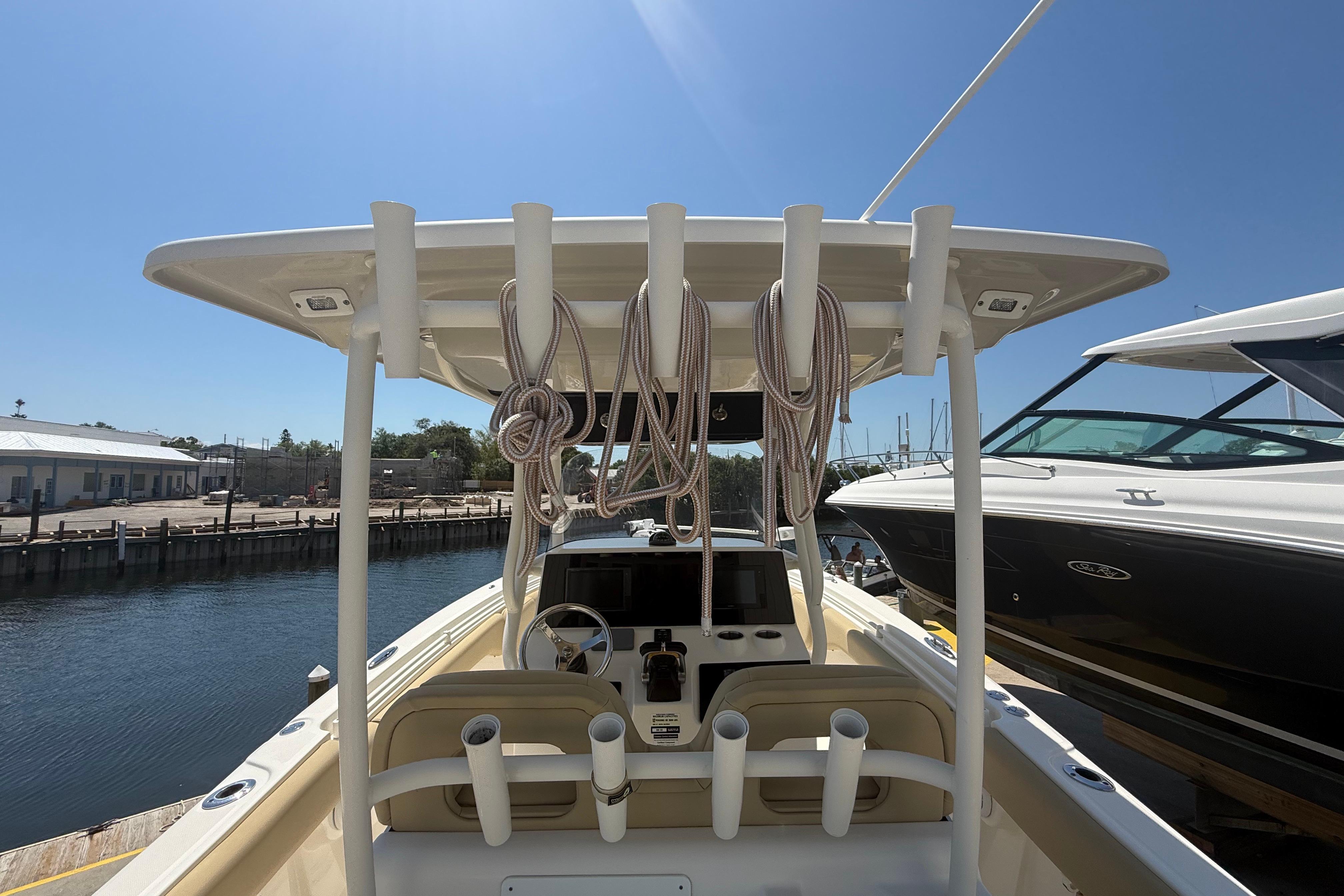 2019 Key West Billistic 281 Center Console boat docked at marina, sunny day.
