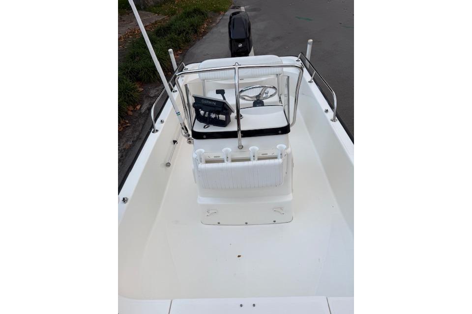 2016 Boston Whaler 150 Montauk boat interior with steering console and seating.