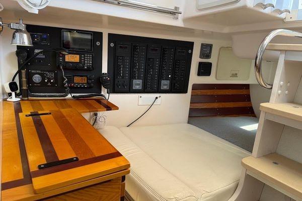 Interior of 2011 Reliance 44 sailboat with navigation equipment and wooden desk.