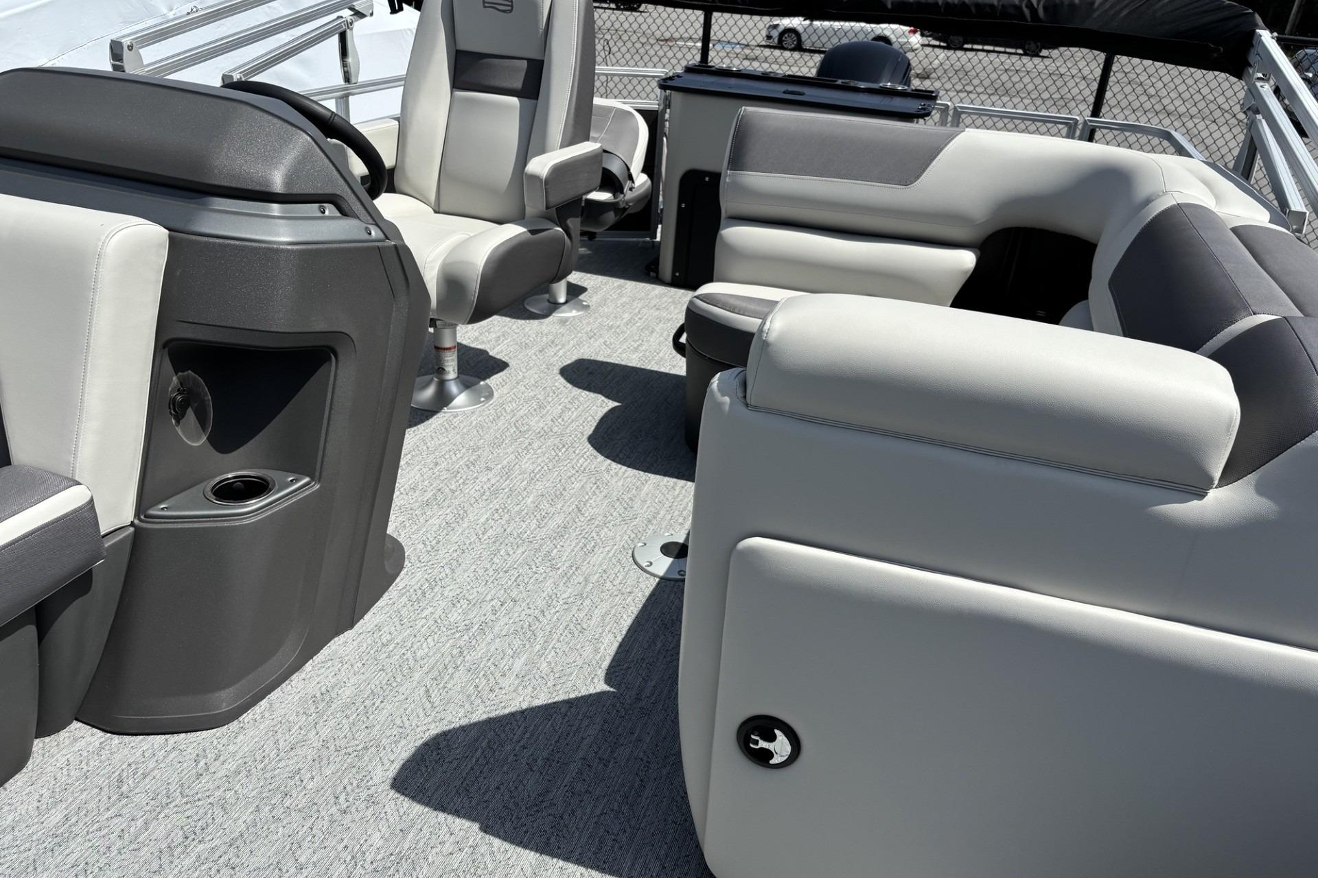 2026 Sun Tracker Fishin' Barge 20 DLX interior with plush seating and modern console design.