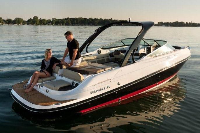 2017 Rinker QX29 BR boat on calm water with two people.