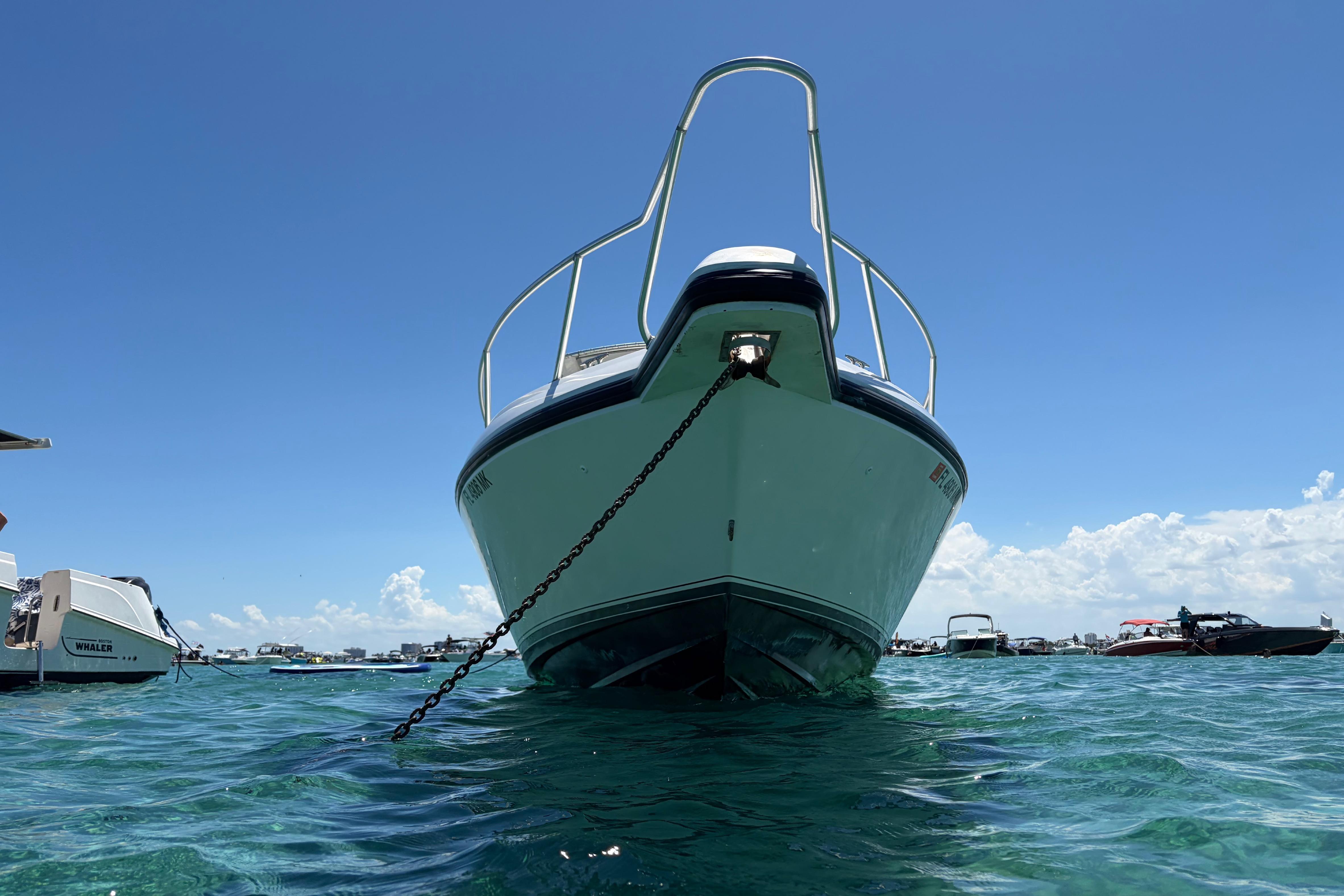 1998 Intrepid 339 Walkaround boat anchored in clear blue water under a sunny sky.