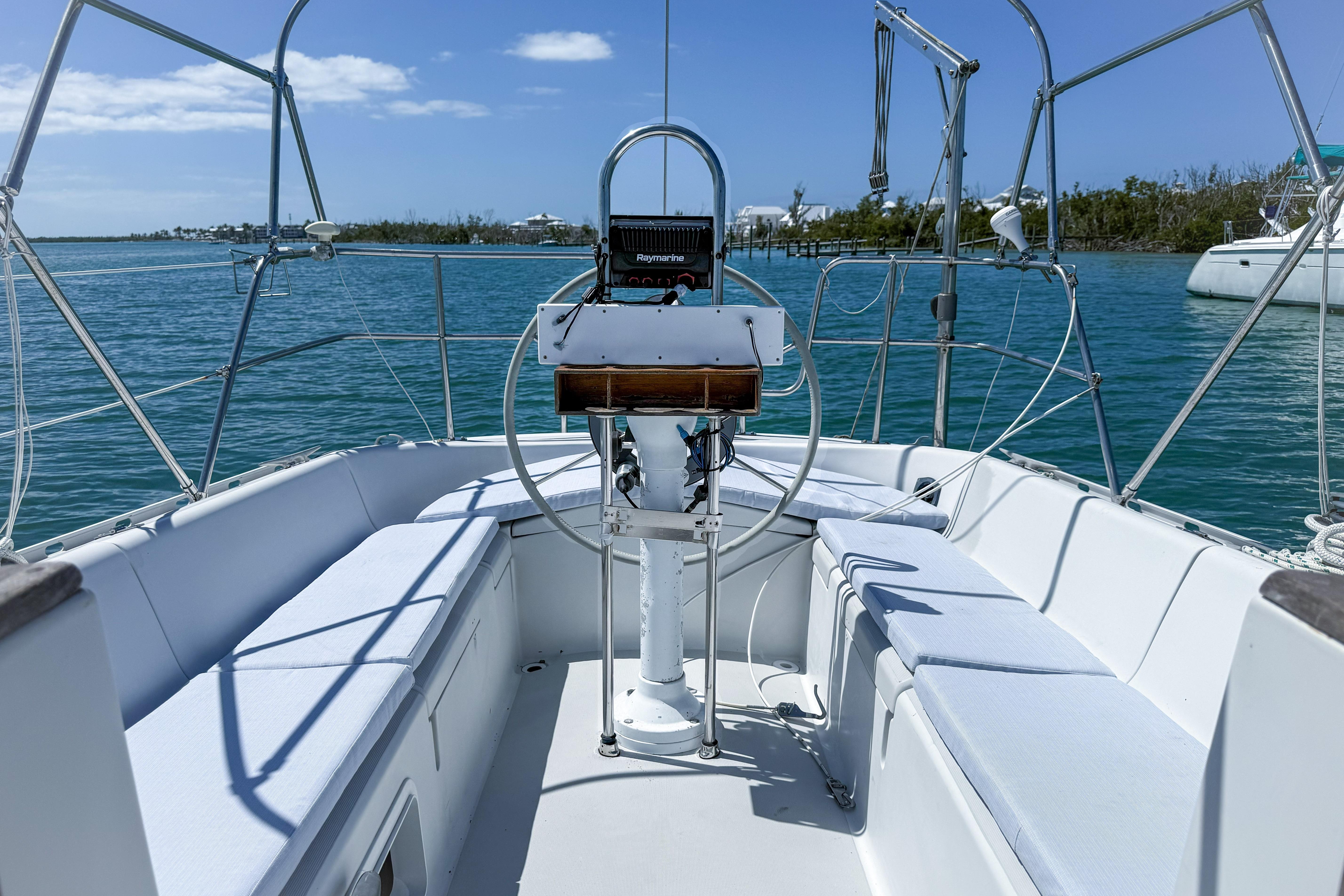 Cockpit of a 1988 Oday 40 sailboat on calm waters under a clear blue sky.