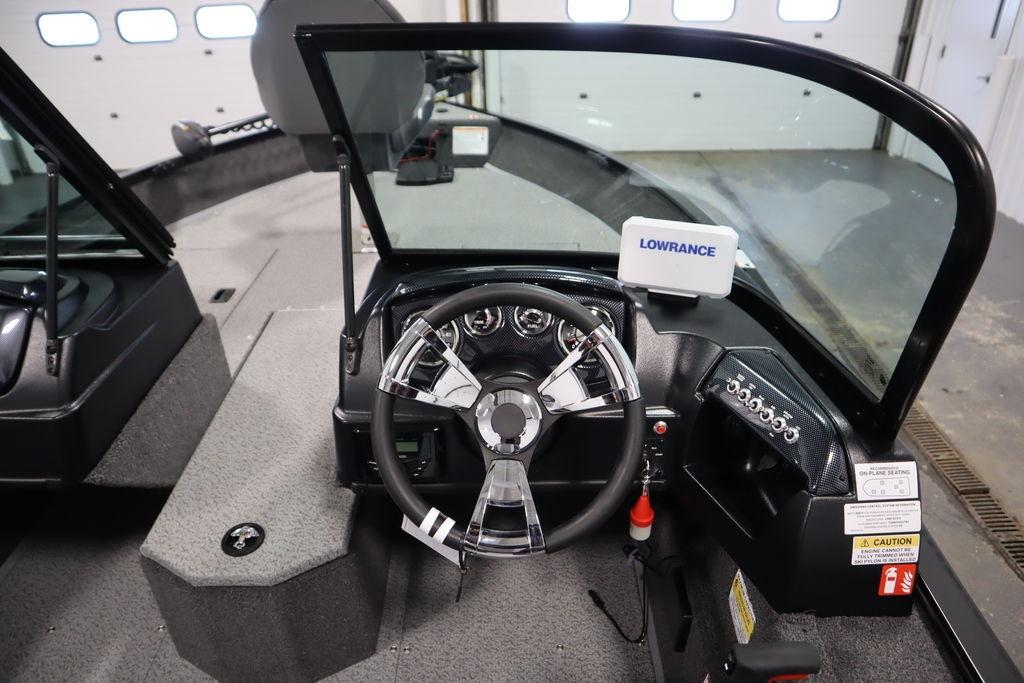 2026 Lowe Fishing Machine 175 dashboard with steering wheel and Lowrance navigation system.